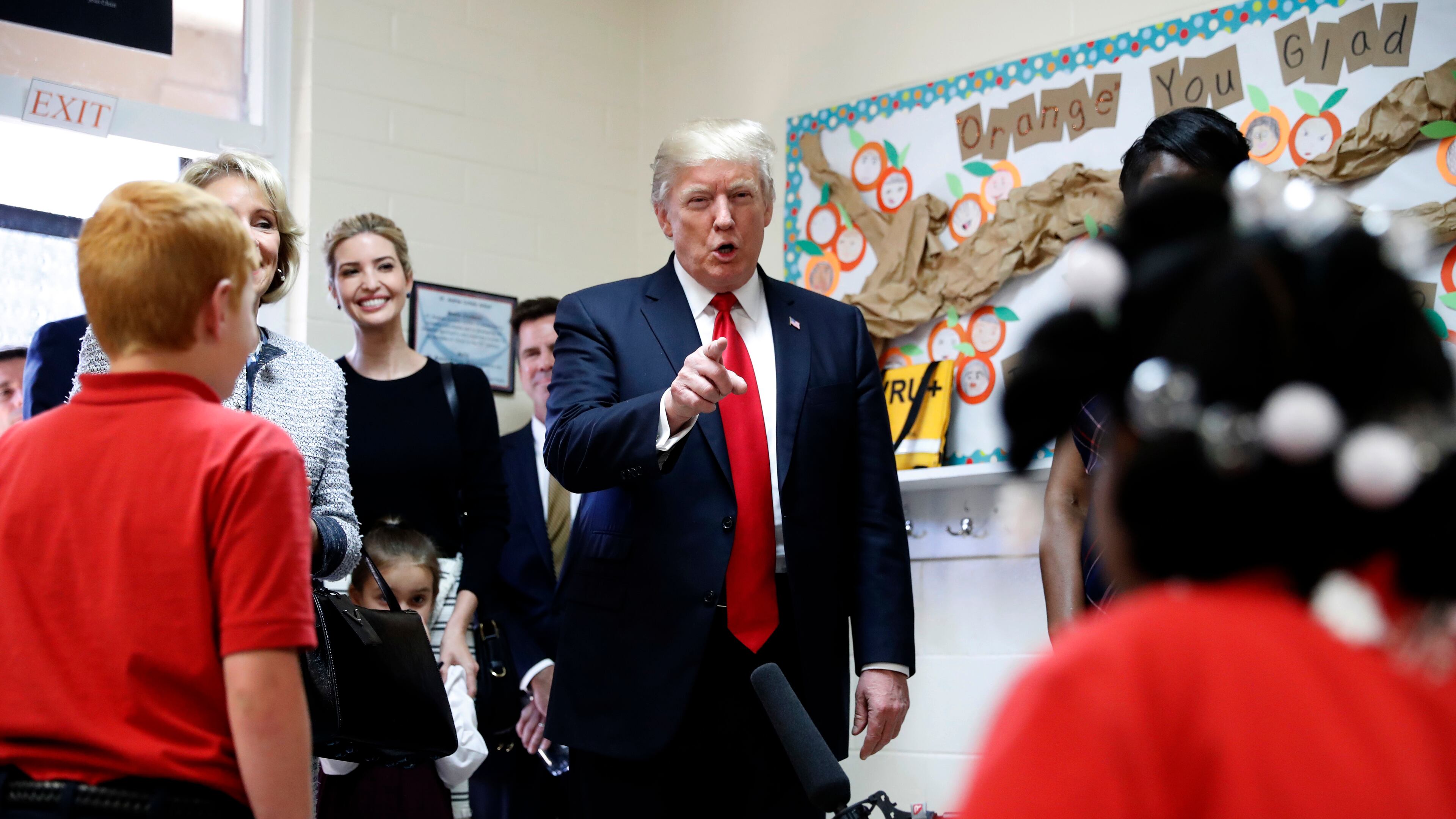 President Donald Trump talks to children in Jane Jones fourth grade class during a tour of Saint Andrew Catholic School, Friday, March 3, 2017, in Orlando, Fla. At left is Trump's daughter Ivanka Trump. (AP Photo/Alex Brandon)