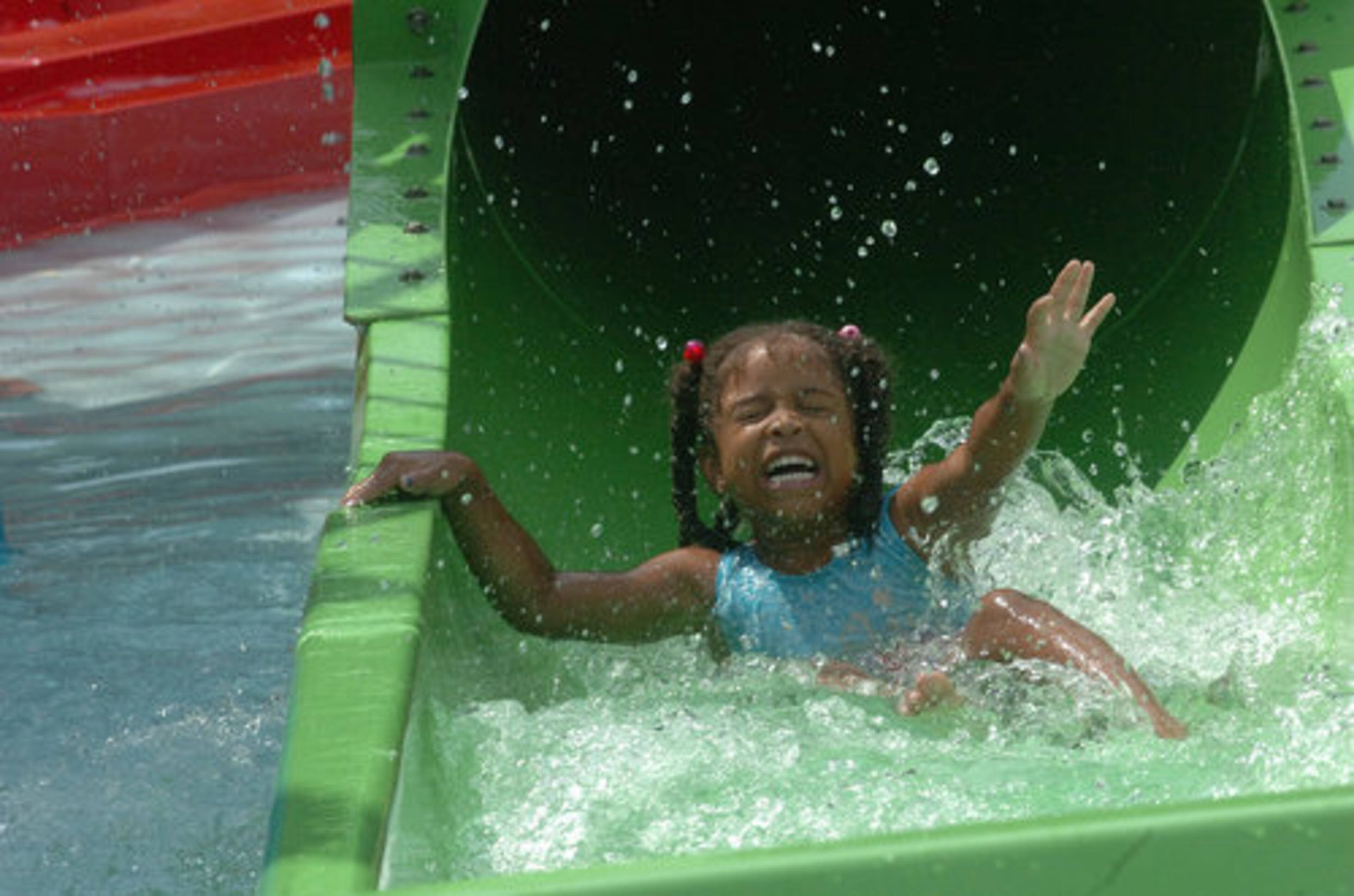 Ayanna Wingo, 5, slides down the water slide for smaller kids.