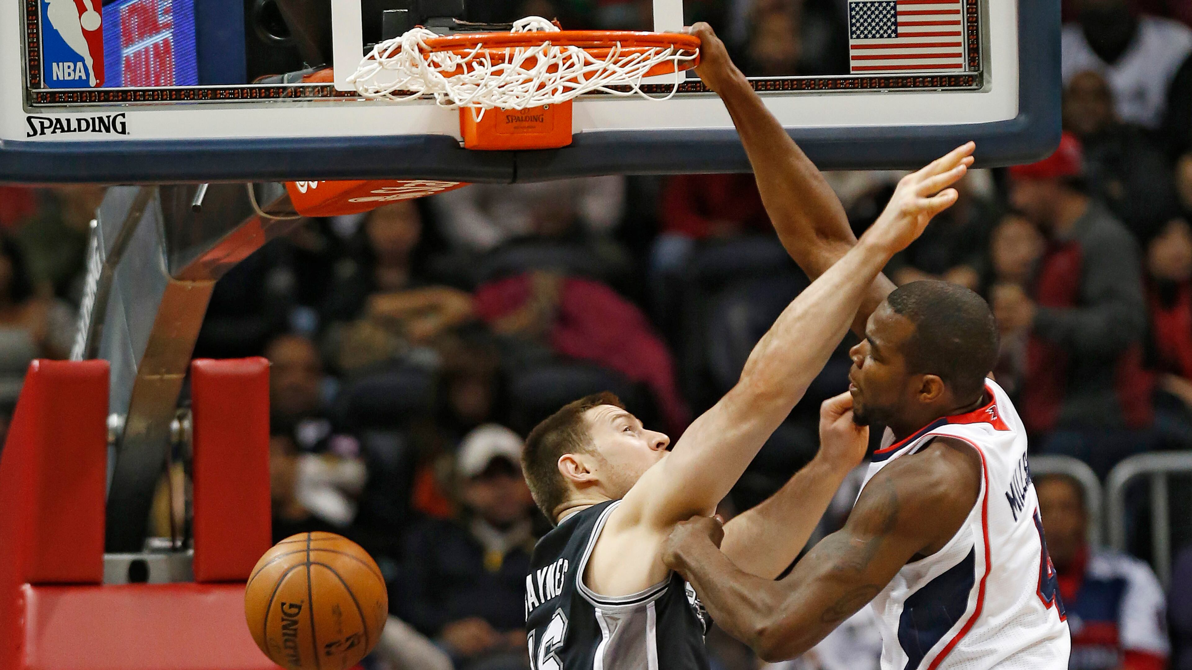 Hawks power forward Paul Millsap dunks on the Spurs' Aron Baynes (16).
