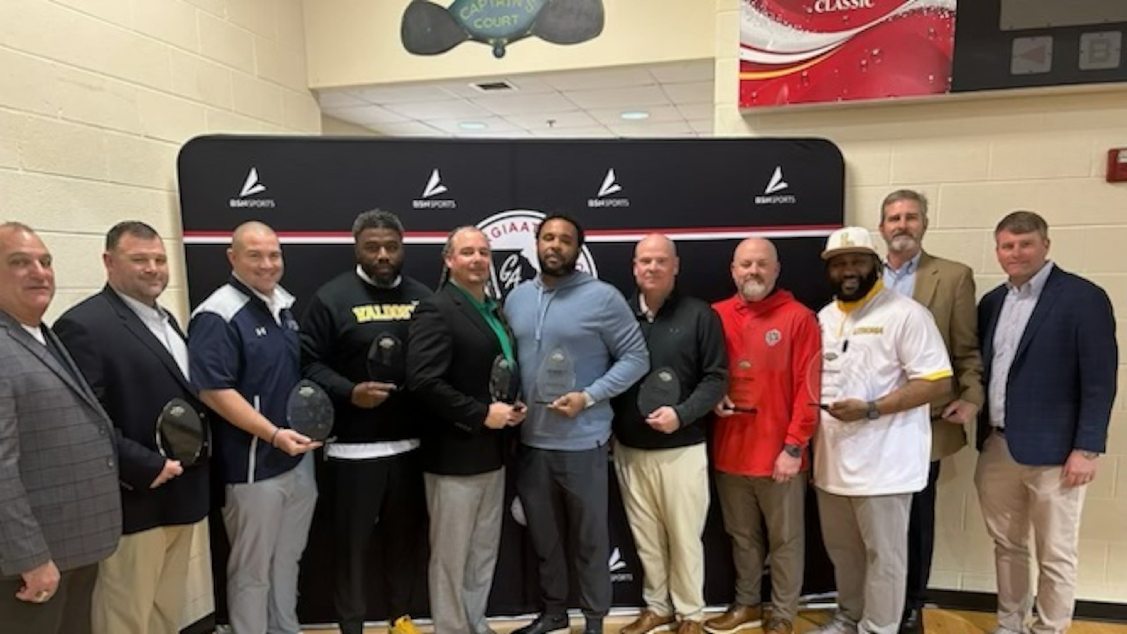 GHSF Daily/AJC Varsity honored nine winners of the Improvement Tracker Award in Macon on Tuesday. From left are Keith Maloof with sponsor Formetco, Randy Crutchfield of Haralson County, Shelton Felton of Valdosta, Chuck Holland of Franklin County, Cap Burnett of North Clayton, Ron Duncan of Screven County, Korey Mobbs of Jackson County, Kevin Barnes of Lithonia, Tommy Lewis of Landmark Christian and Matt Leech with sponsor Formetco. (AJC)