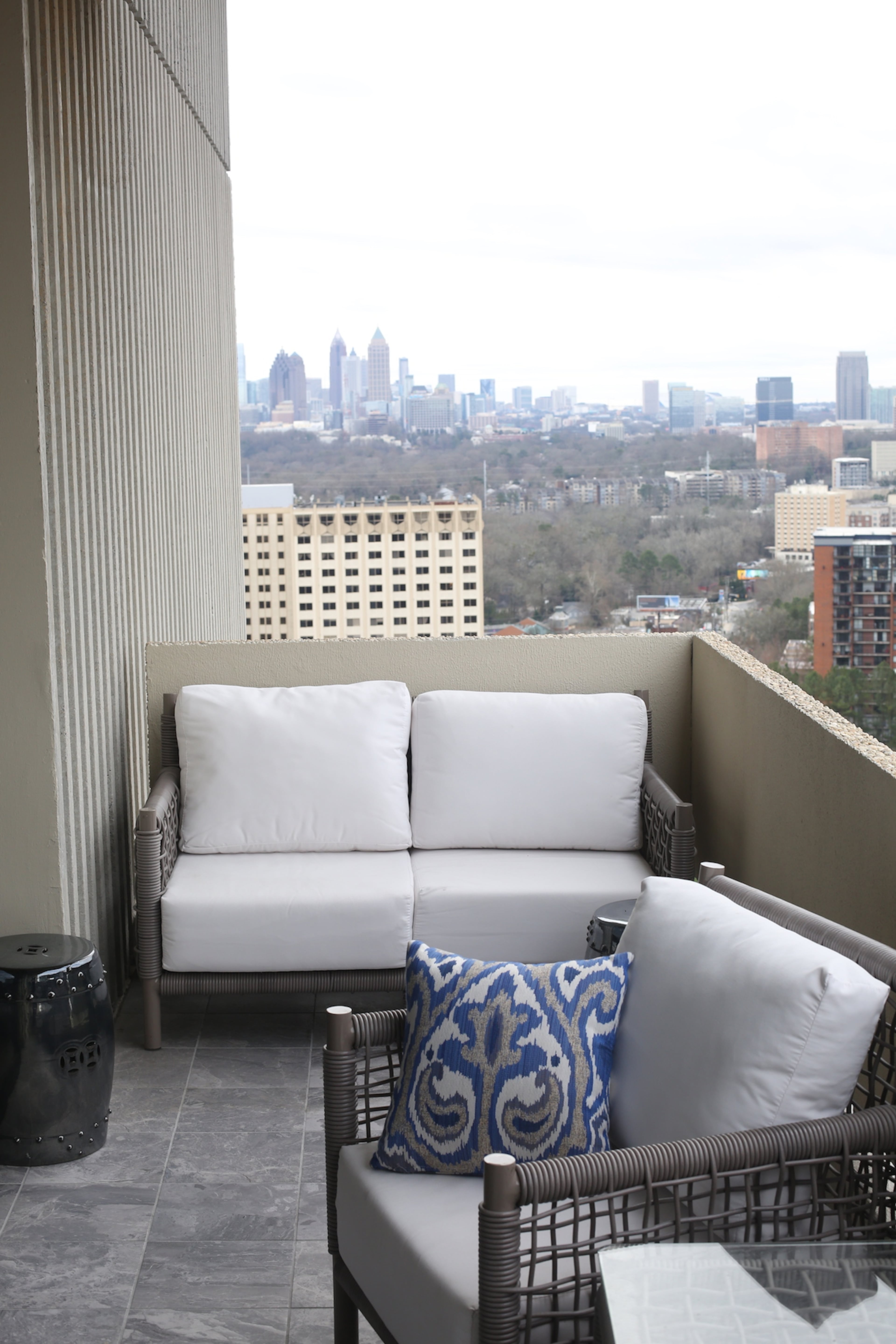 Chairs from Kannoa provide a perch to take in the city views from the terrace of the Buckhead condo. The Emissary stools are sourced from JDouglas.
