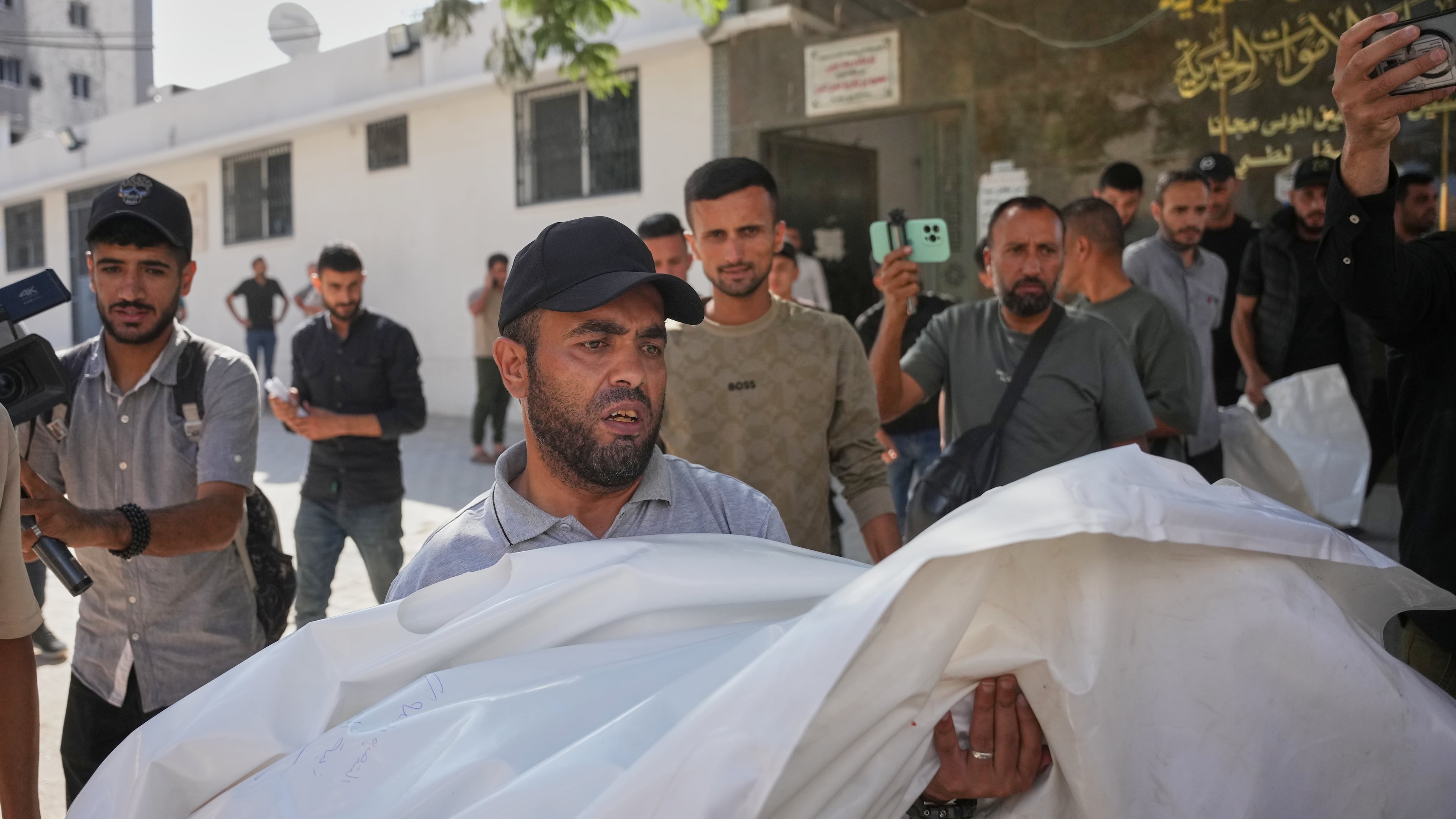 Mourners carry the bodies of two Palestinian girls Zeina Safadi, and her sister Lana, who were killed during an overnight Israeli airstrike that damaged their home, during their funeral in Gaza city, Saturday, June 20, 2026. (AP Photo/Abdel Kareem Hana)