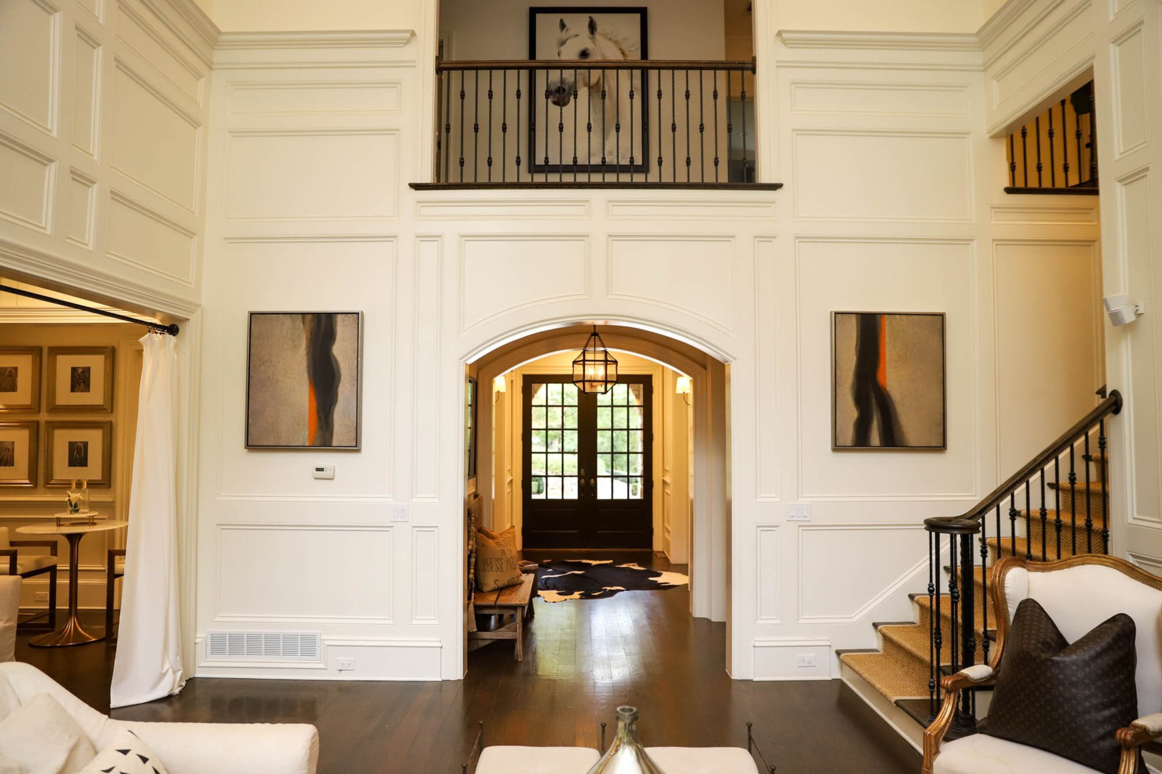 Two paintings by homeowner Dana Spinola’s father Myott of Myott Studio frame the doorway in the living room of Spinola’s home. Both of her parents are artists, so much of her decor and furniture is inspired or sourced through them and their community. Text by Shannon Dominy. Photo by Reynolds Rogers.