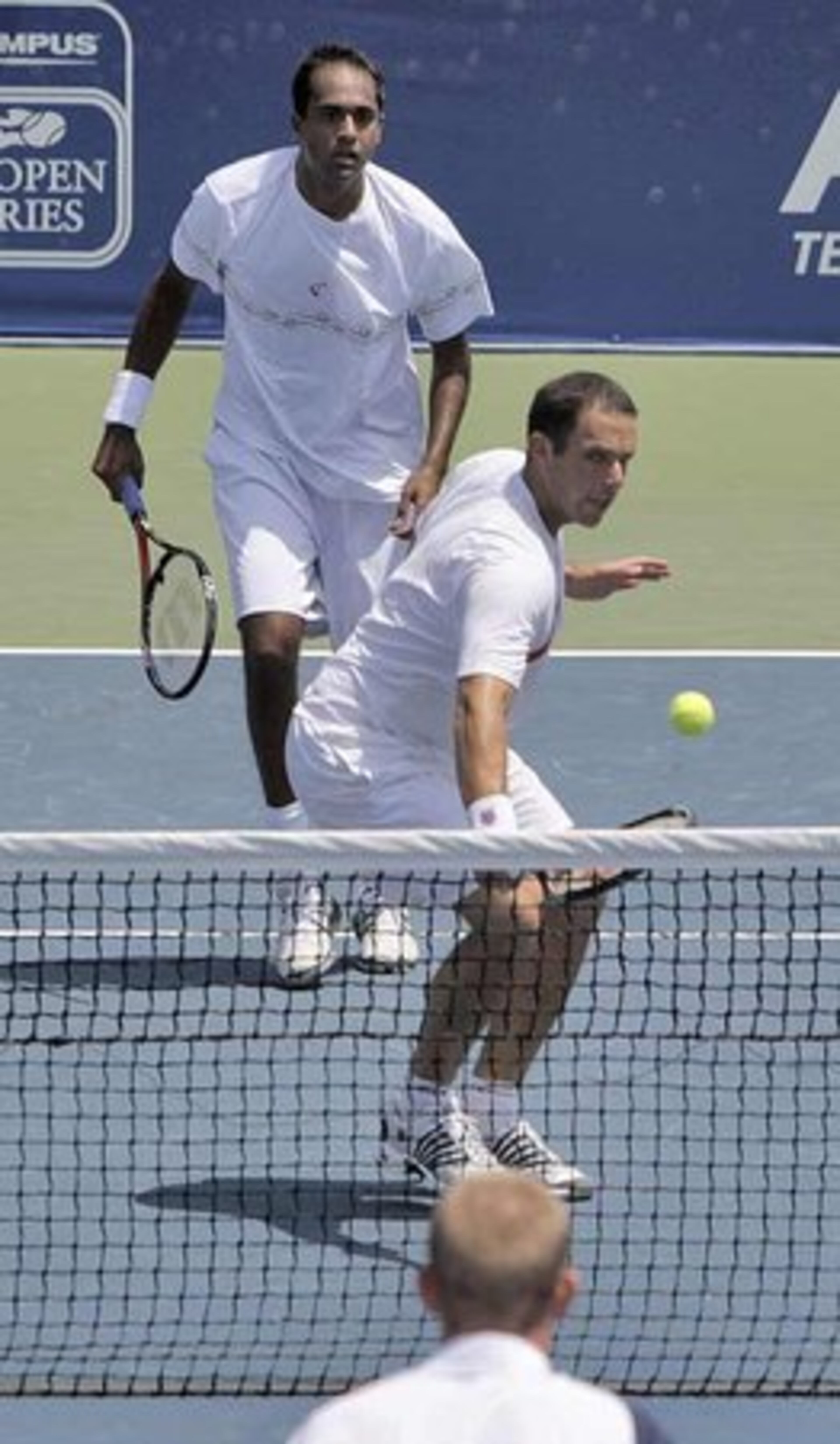 Rajeev Ram and Scott Lipsky (USA) (in front) in the doubles match they won in a tie breaker. In the foreground is Kristof Vliegen (BEL). The Atlanta Tennis Championships finals in Johns Creek featured the team of Rohan Bopanna (IND) and Kristof Vliegen (BEL) against Scott Lipsky (USA) and Rajeev Ram (USA) in doubles and Mardy Fish vs. John Isner in singles. Sunday, July 25, 2010.
