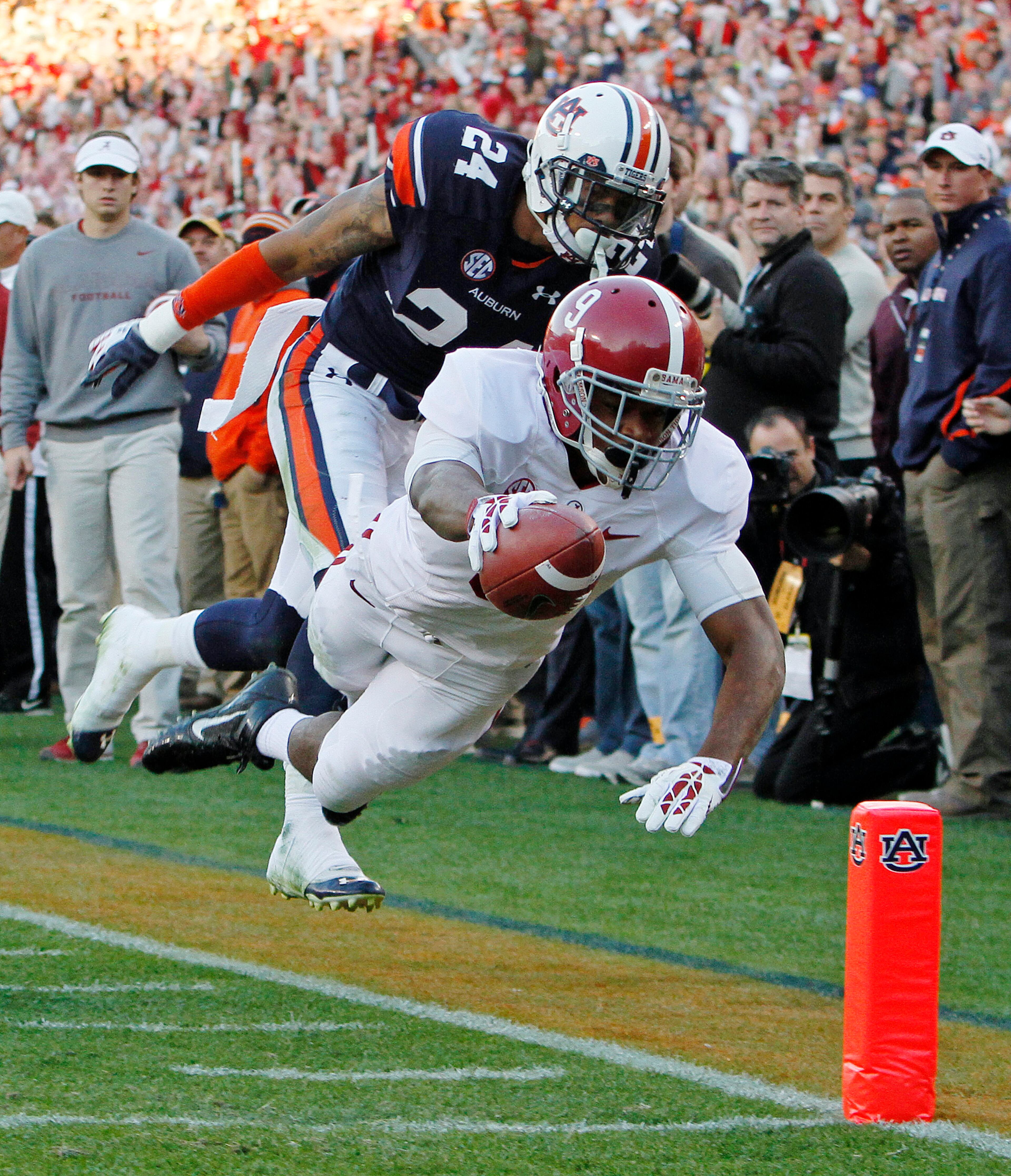 Alabama wide receiver Amari Cooper (9) dives for the end zone as Auburn defensive back Ryan Smith (24) defends during the first half of an NCAA college football game in Auburn, Ala., Saturday, Nov. 30, 2013. Cooper was ruled short of the goal line, but Alabama scored on the next play.