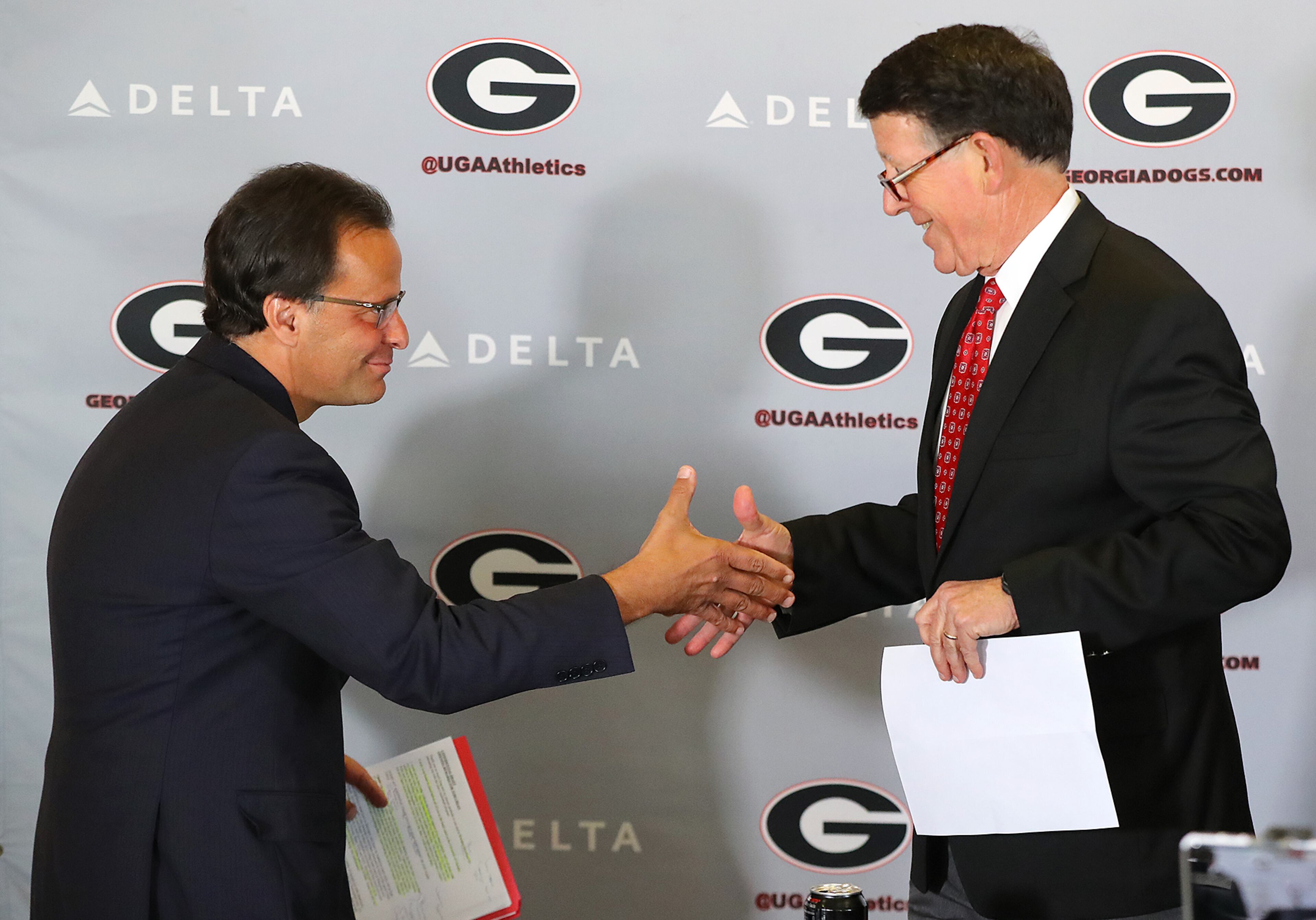 March 16, 2018 Athens: Georgia athletics director Greg McGarity (right) introduces Tom Crean as the new men's basketball head coach at the University of Georgia on Friday, March 16, 2018, at Stegeman Coliseum in Athens. Crean compiled a 356-231 record in 18 seasons at Marquette and Indiana from 1999-2017. Curtis Compton/ccompton@ajc.com