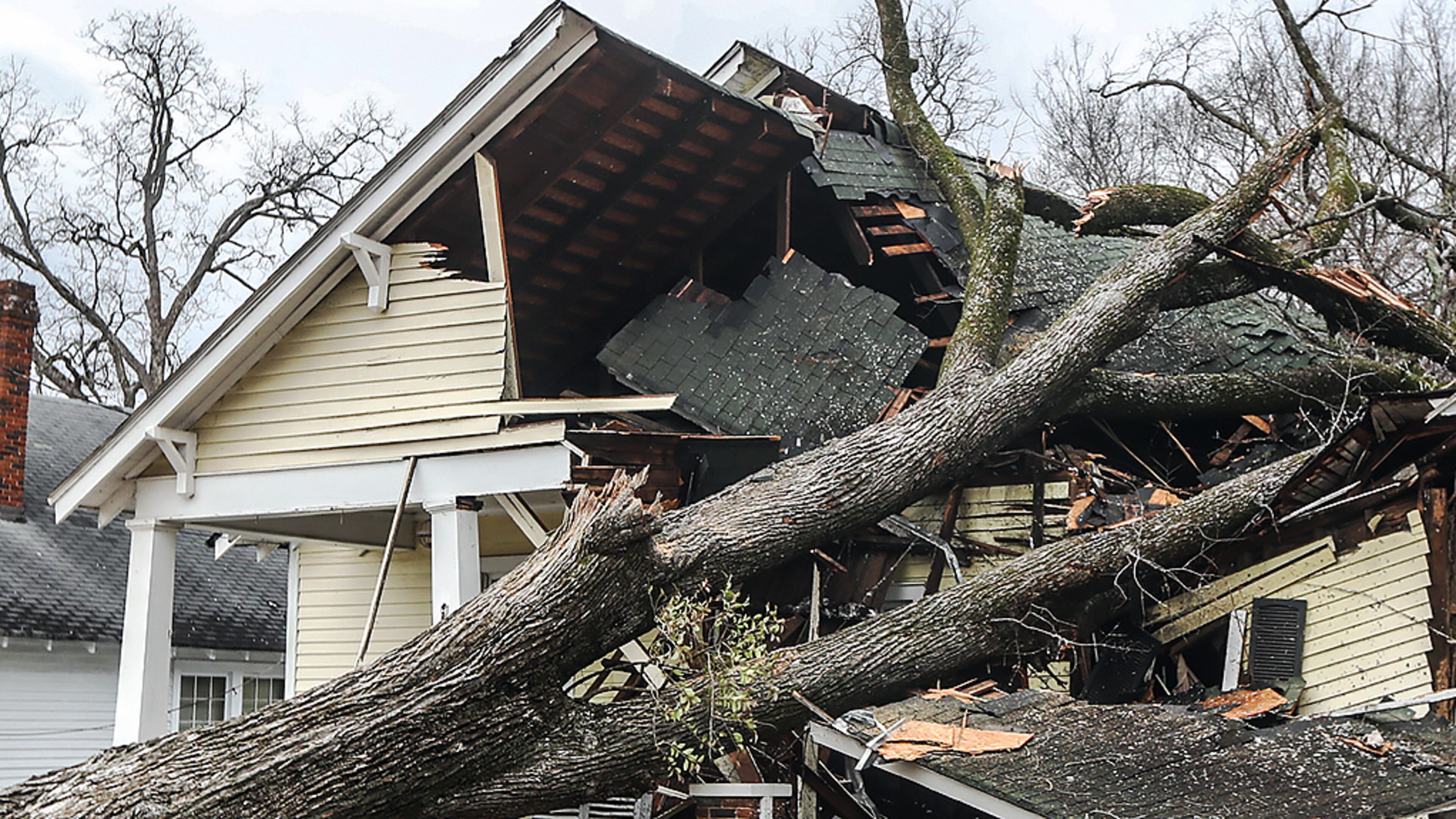 Adam Smith with Green Tree Service surveys the damage on West Chappell Street in Griffin on Jan. 13.