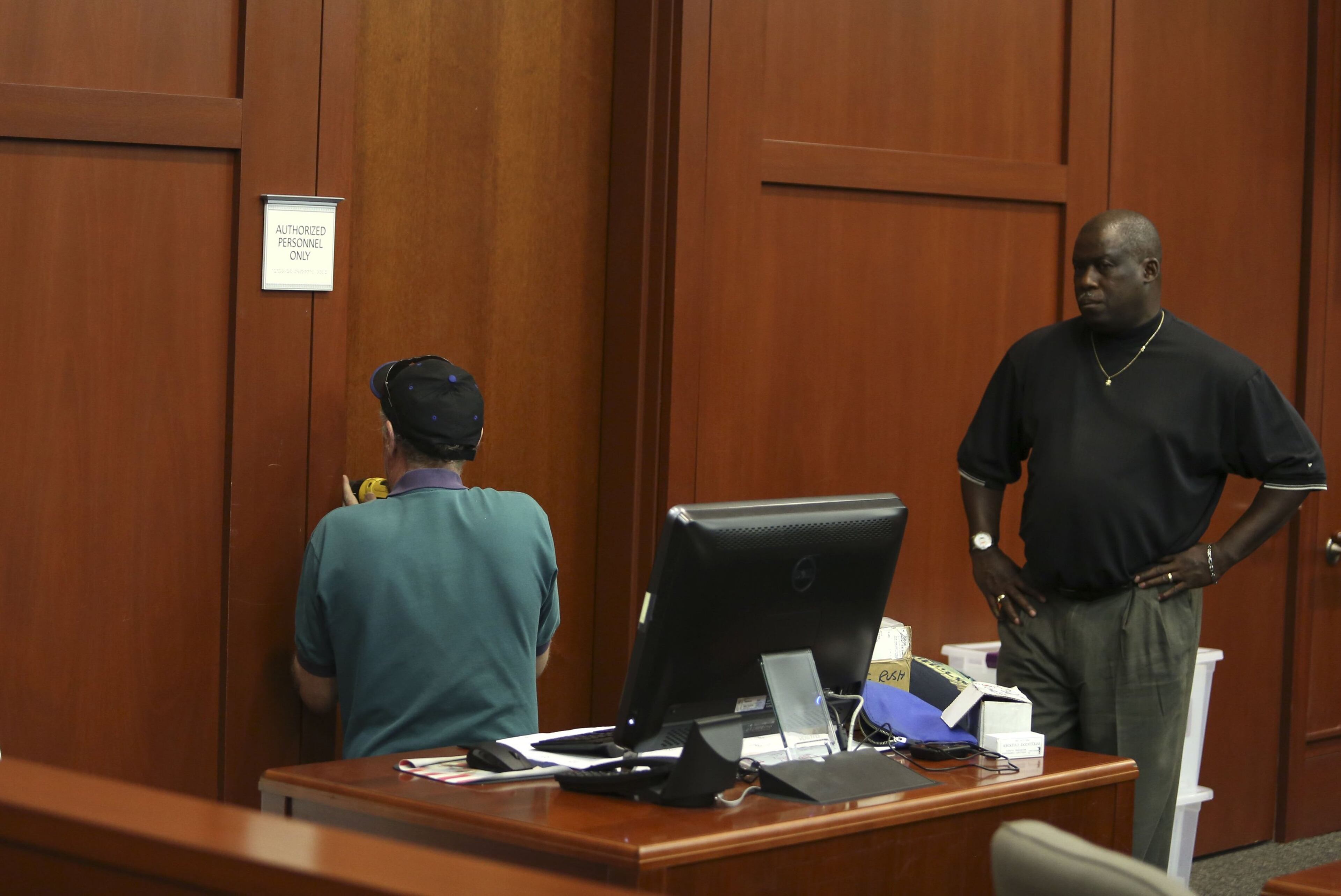 A locksmith drills into the door of the evidence room where the electronic lock had failed on Friday, July 5, 2013, in the trial of George Zimmerman in Sanford, Florida. Zimmerman is charged in the death of Trayvon Martin (Gary W. Green/Orlando Sentinel/MCT)