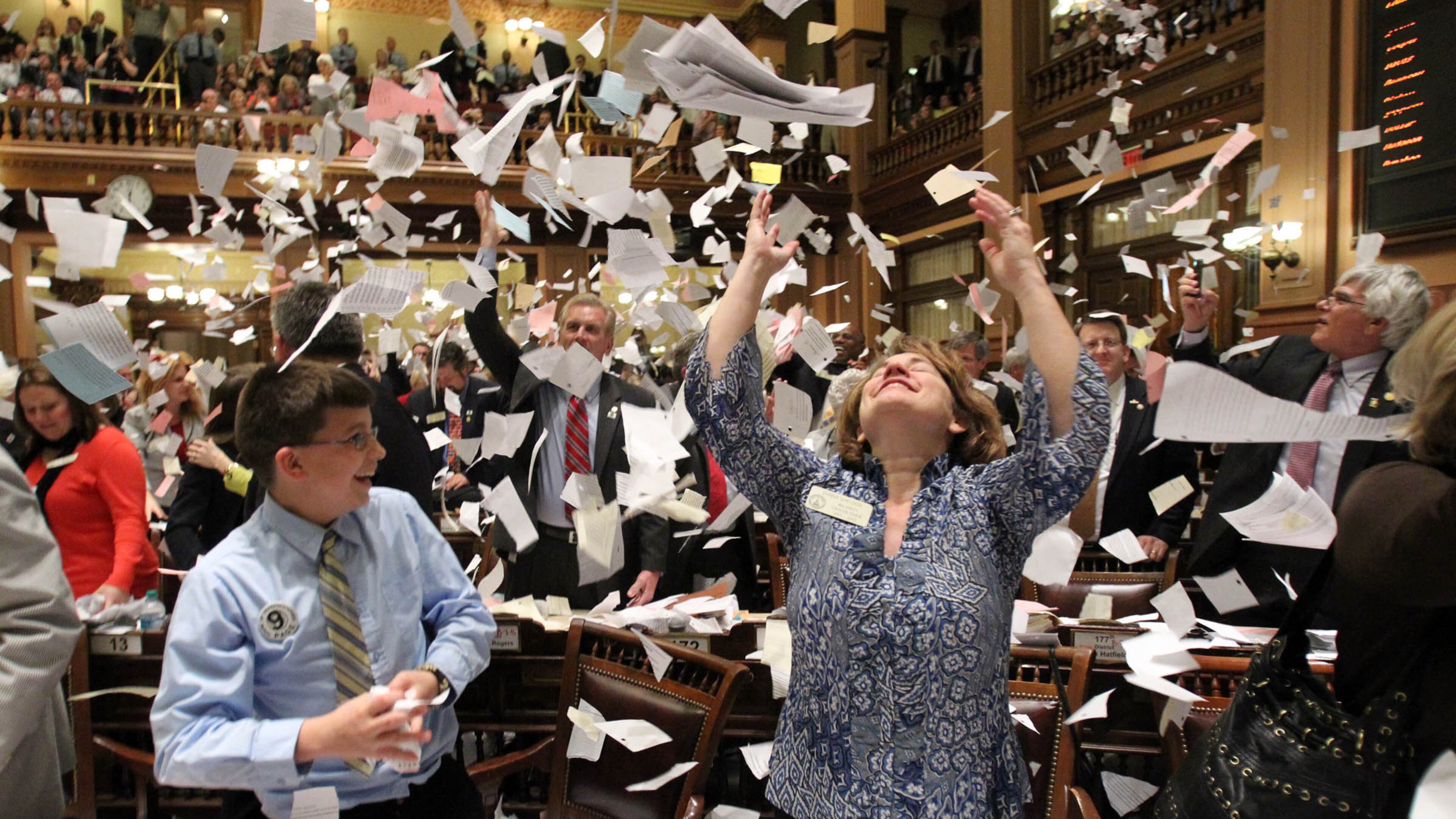 March 29, 2012 ATLANTA: Rep. Donna Sheldon, R-Dacula, center, throws paper into the air next to Thomas Allison after the House Majority Leader, Rep. Larry O'Neal yelled, "Sine Die, " to end the 2012 Legislative Session at the stroke of midnight on Legislative Day 40 at the Capitol Thursday afternoon in Atlanta, Ga., March 29, 2012. This was the finale of a three-month assignment to photograph the 2012 Legislative Session. I've heard a lot about, "Sine Die, " and enjoyed covering the event. I was focused on the Speaker of the House and waited for someone to react after throwing paper in the air. I saw Rep. Sheldon toss paper in the air and quickly turned to get off a few frames. I was happy to get a few before she put her arms down. Jason Getz jgetz@ajc.com