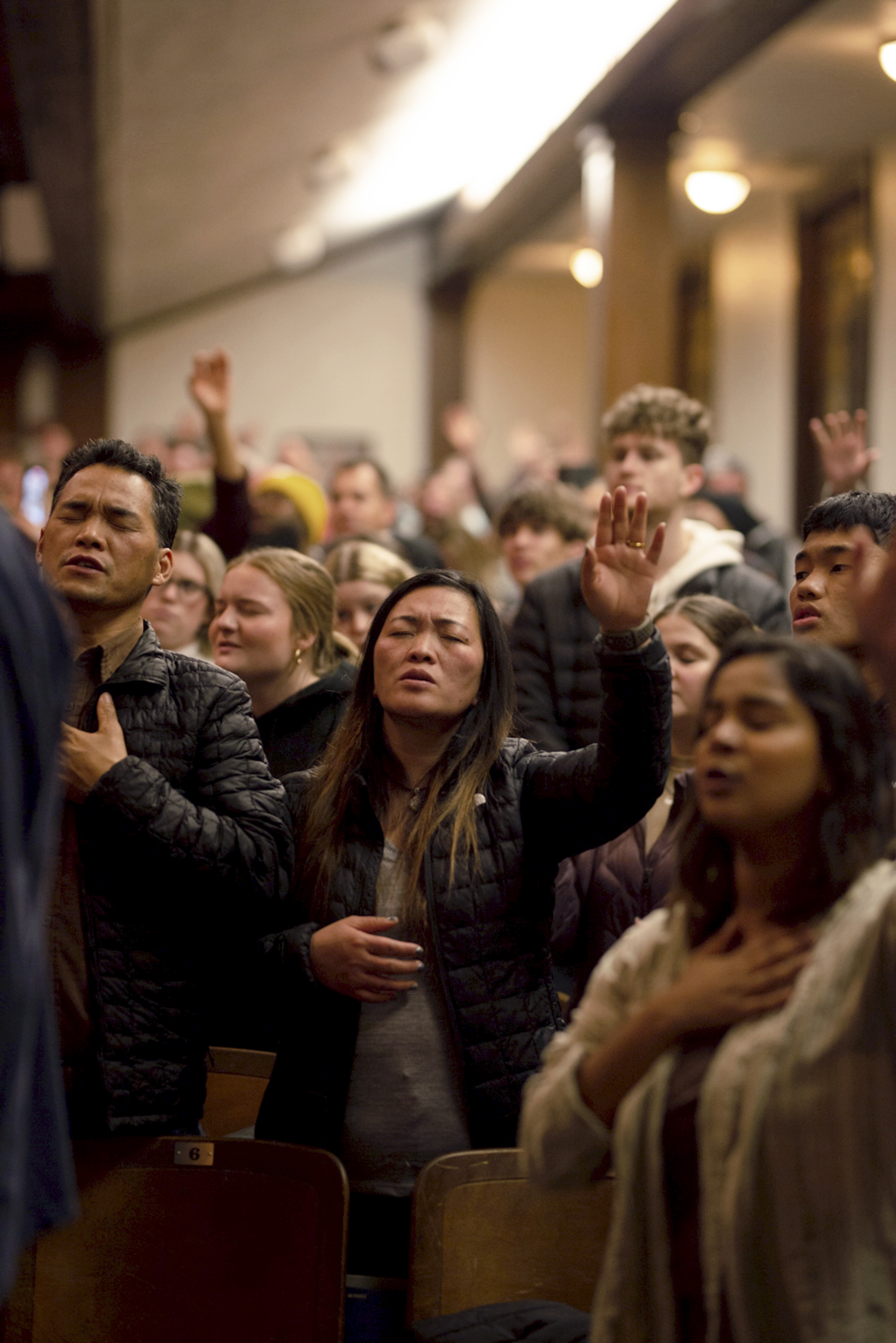 Attendees during worship inside Hughes Chapel on the campus of Asbury University in Wilmore, Ky., on Feb. 18, 2023. Over two weeks, more than 50,000 people descended on a small campus chapel to experience the nation’s first major spiritual revival in decades — one driven by Gen Z. (Jesse Barber/The New York Times)