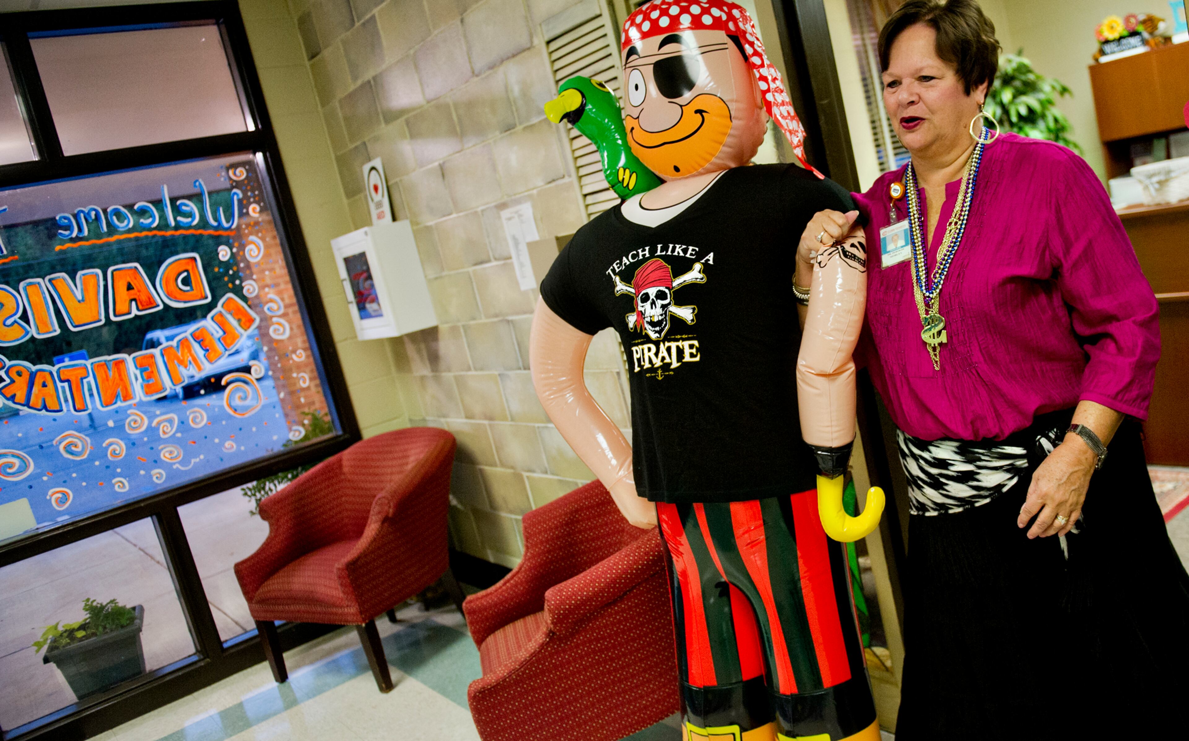 Principal Dr. Dee Mobley carries an inflatable pirate out of the office as she waits for students to arrive during the first day of classes at Davis Elementary School in Marietta on Monday, August 4, 2014. Teachers and administrators at the school dressed as pirates for the first day of school. Students in Cobb County and Atlanta public schools headed back to class on Monday for the new school year. JONATHAN PHILLIPS / SPECIAL