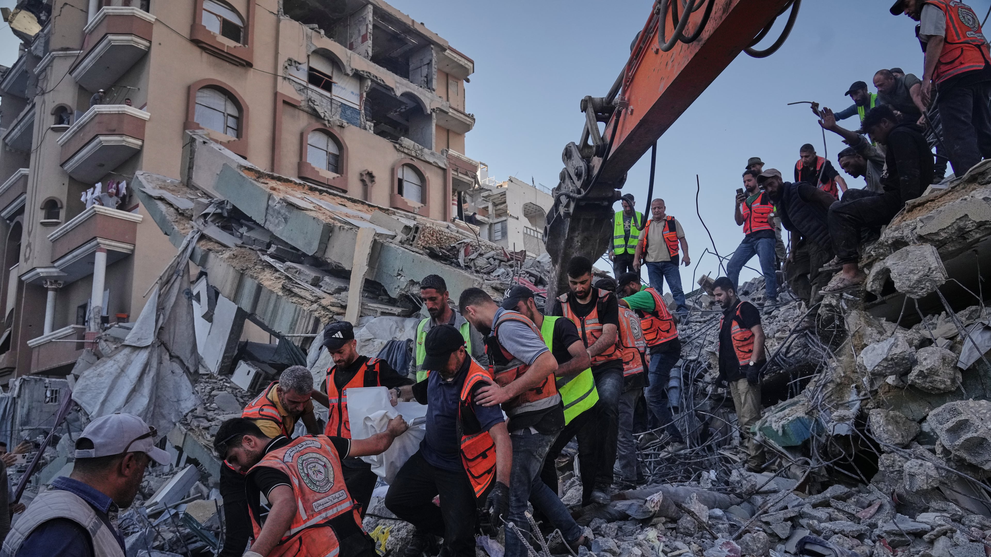 Palestinian civil defense crews carry a body from the rubble of a collapsed building that housed displaced Palestinians and was heavily damaged during the Israel-Hamas war, in Gaza City, Wednesday, Sept. 16, 2026. (AP Photo/Jehad Alshrafi)