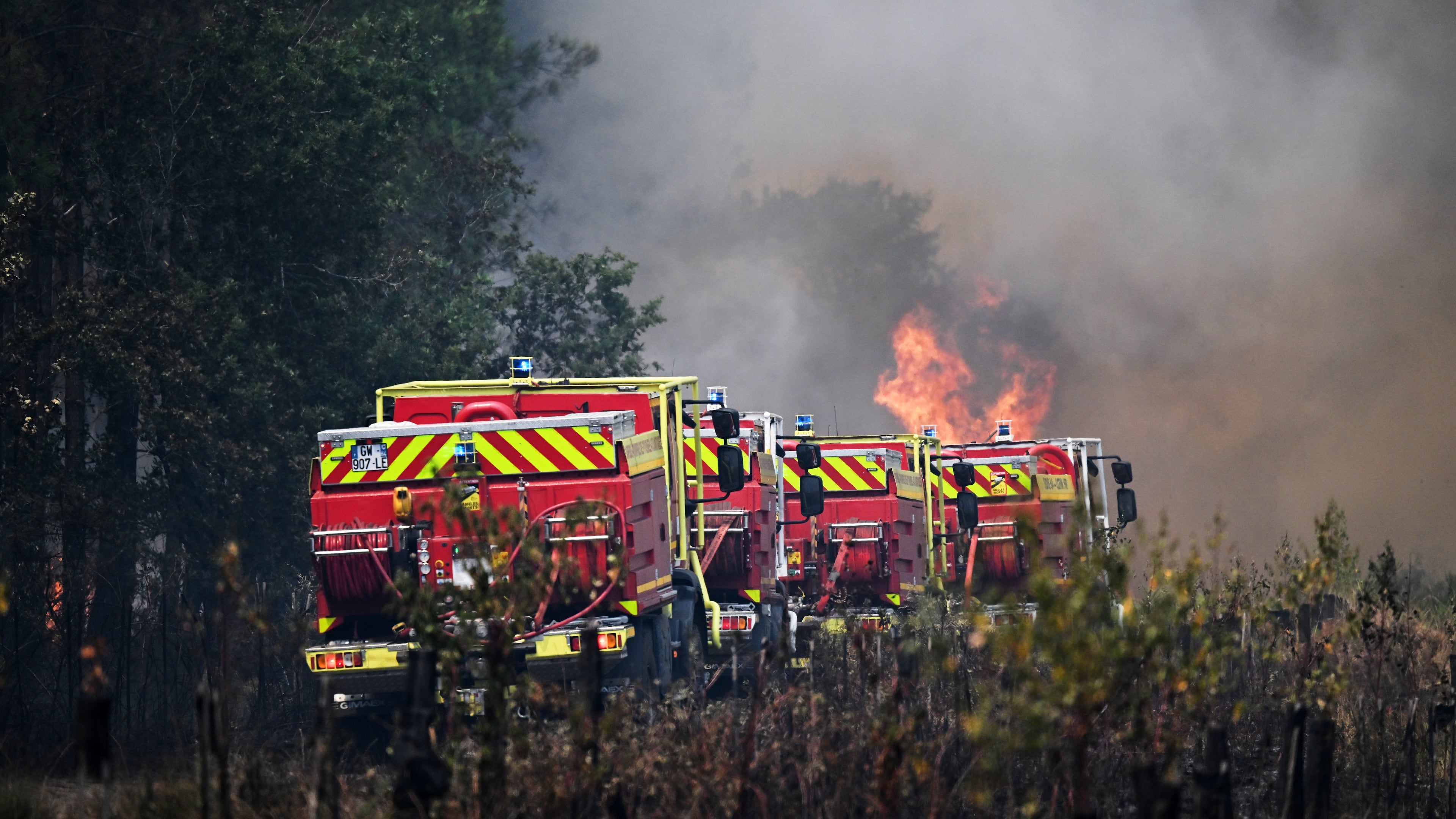 Firefighters tackle a blaze as wildfires rage near Le Las, outside Bordeaux, France, Monday, July 27, 2026. (AP Photo/Emma Da Silva)