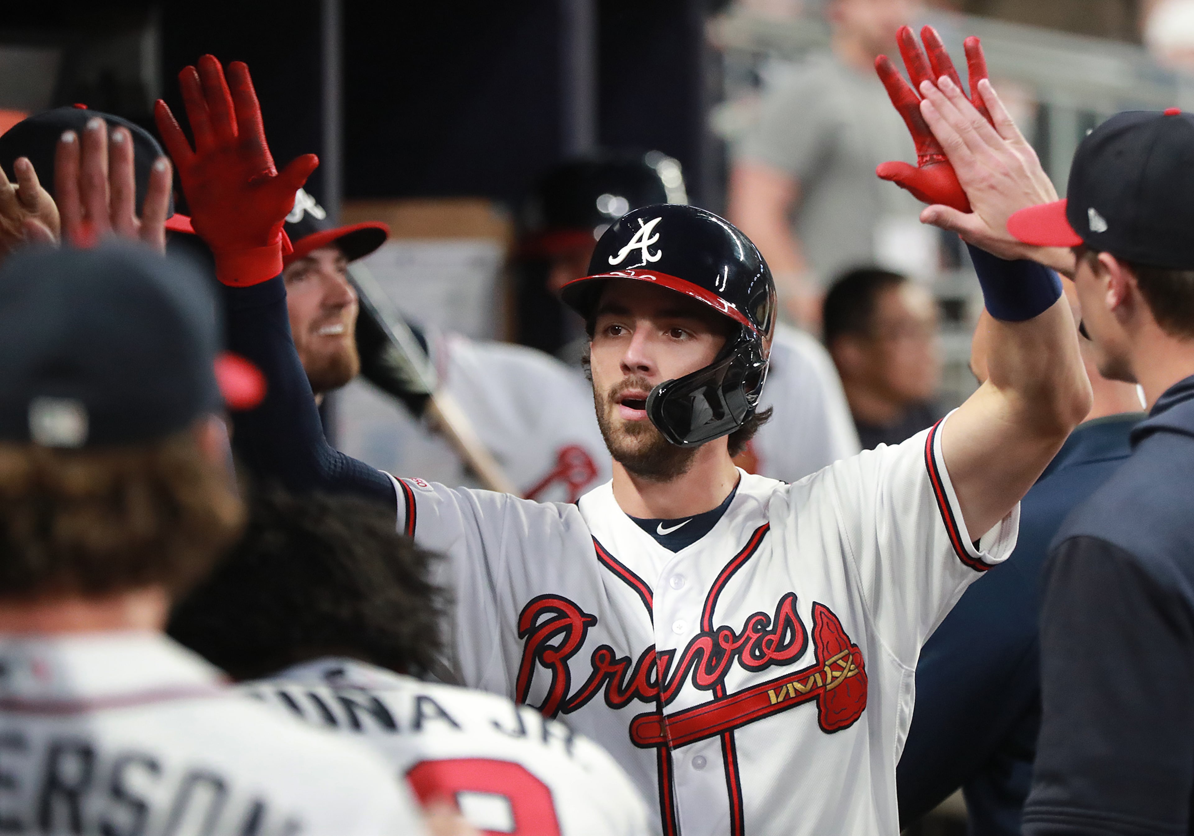 Swanson gets double high fives in the dugout after hitting a solo home run. Curtis Compton/ccompton@ajc.com