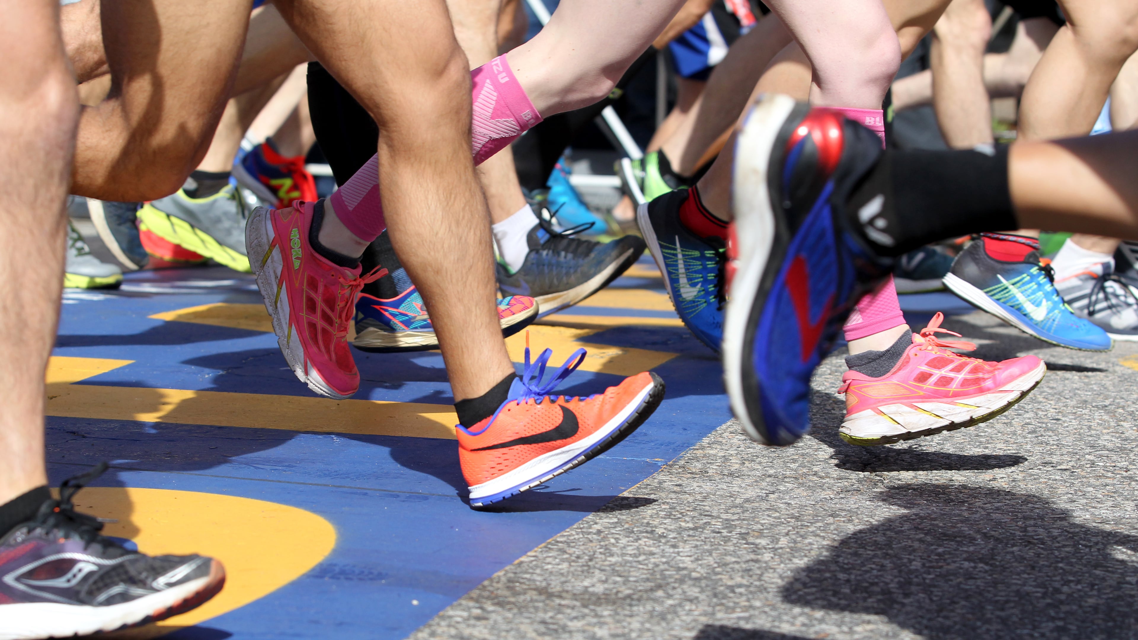 FILE - A colorful collection of shoes cross the starting line at the start of the 2017 Boston Marathon in Hopkinton, Mass., Monday, April 17, 2017. (AP Photo/Mary Schwalm, file)