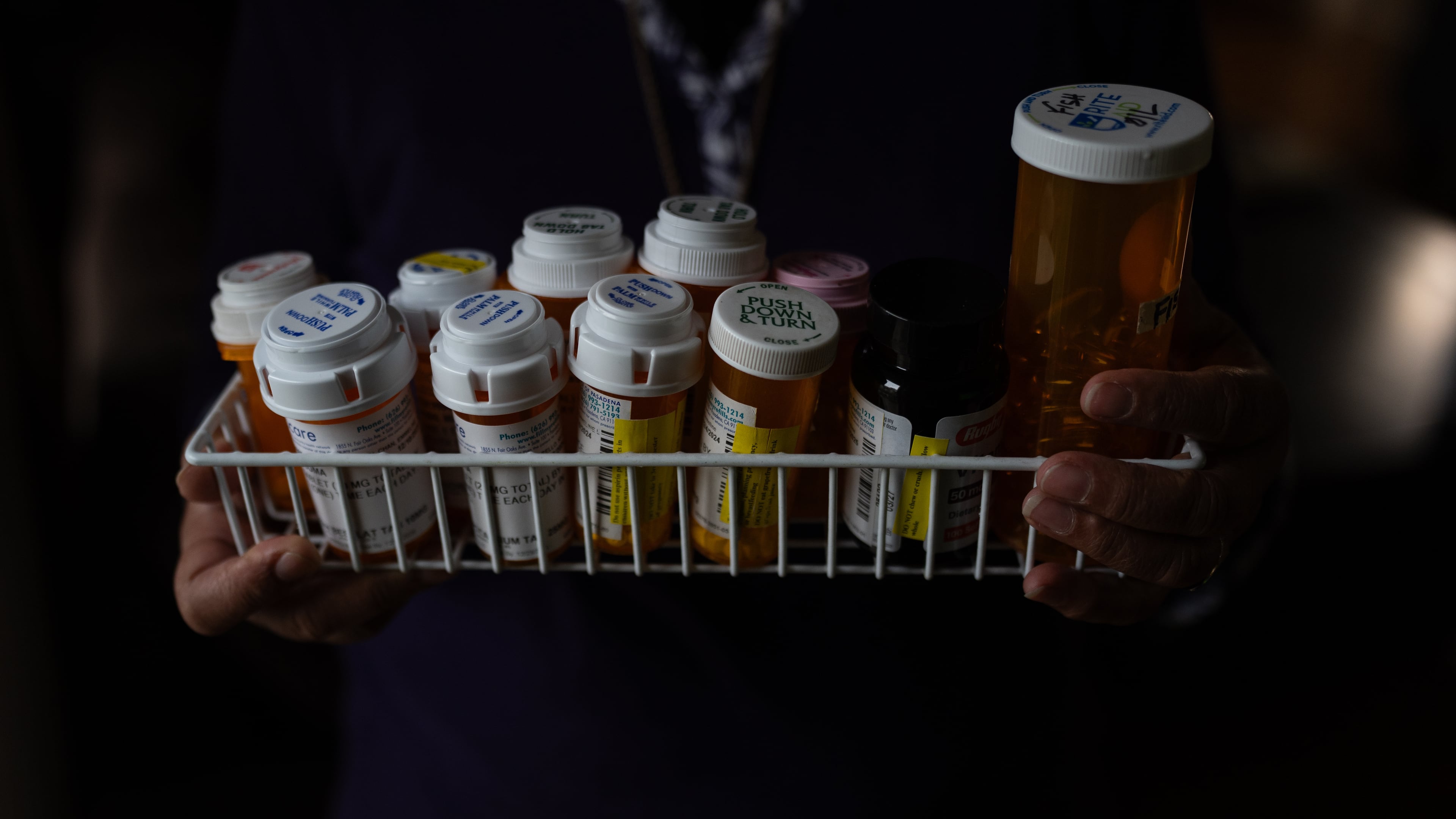 Masuma Khan, an immigrant from Bangladesh who was held at an immigration detention facility in California City the previous year, holds the medications she takes daily, in Altadena, Calif., April 21, 2026. (AP Photo/Jae C. Hong)