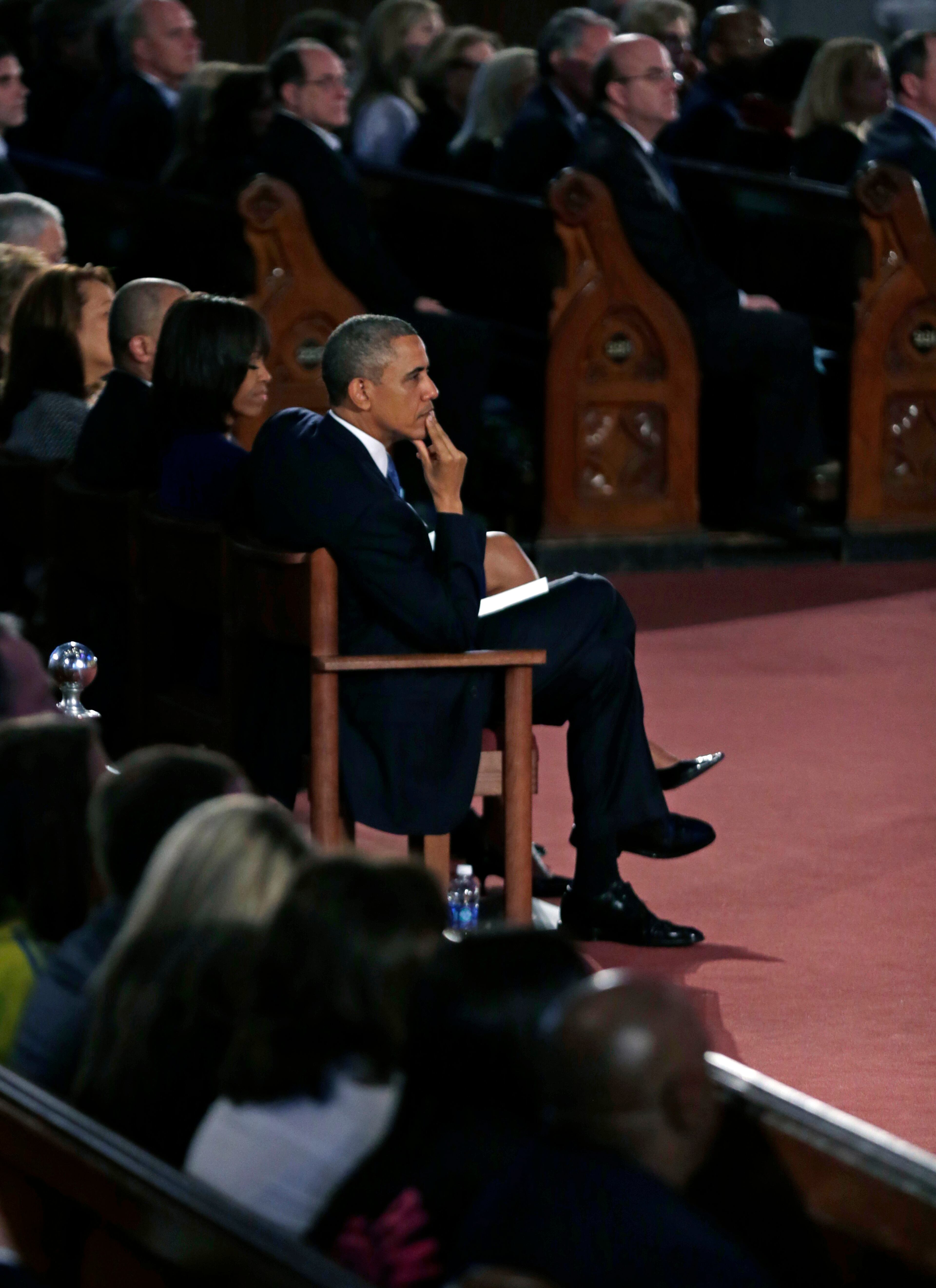 President Barack Obama and first lady Michelle Obama attend an interfaith healing service at the Cathedral of the Holy Cross in Boston.