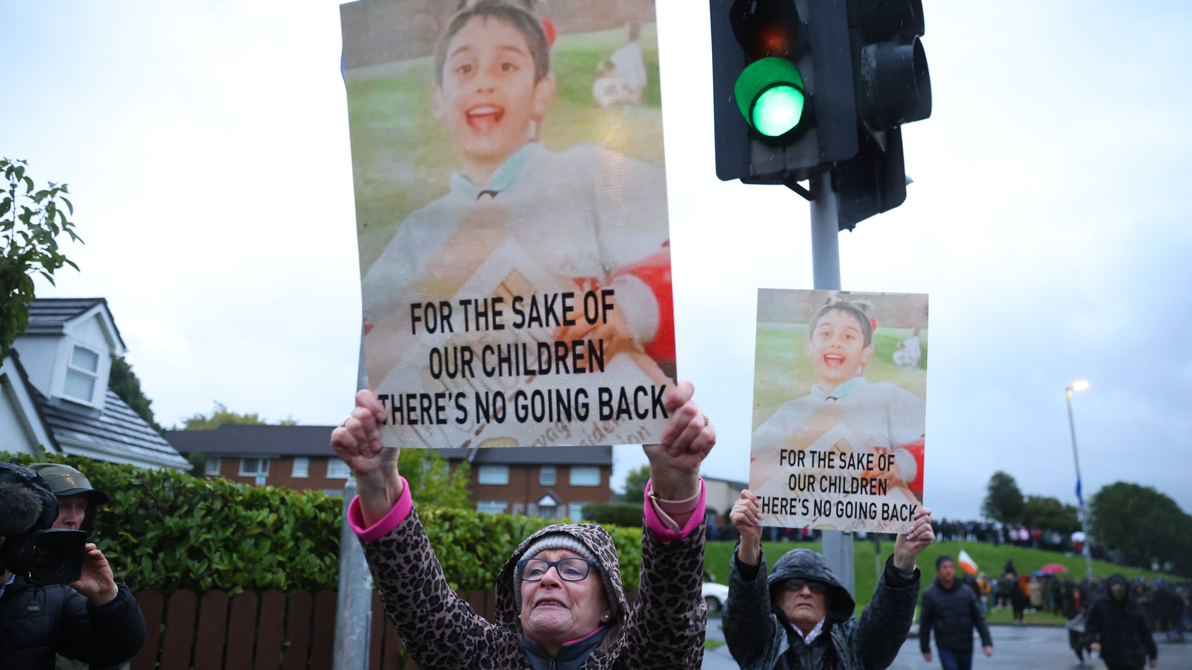 Protesters hold banners ahead of a Portadown District Loyal Orange Lodge (LOL) No 1 march in the first parade for almost 30 years, after the parade was given clearance in a late-night hearing, in Portadown, Northern Ireland, Sunday, Sept. 27, 2026. (Peter Morrison/PA via AP)