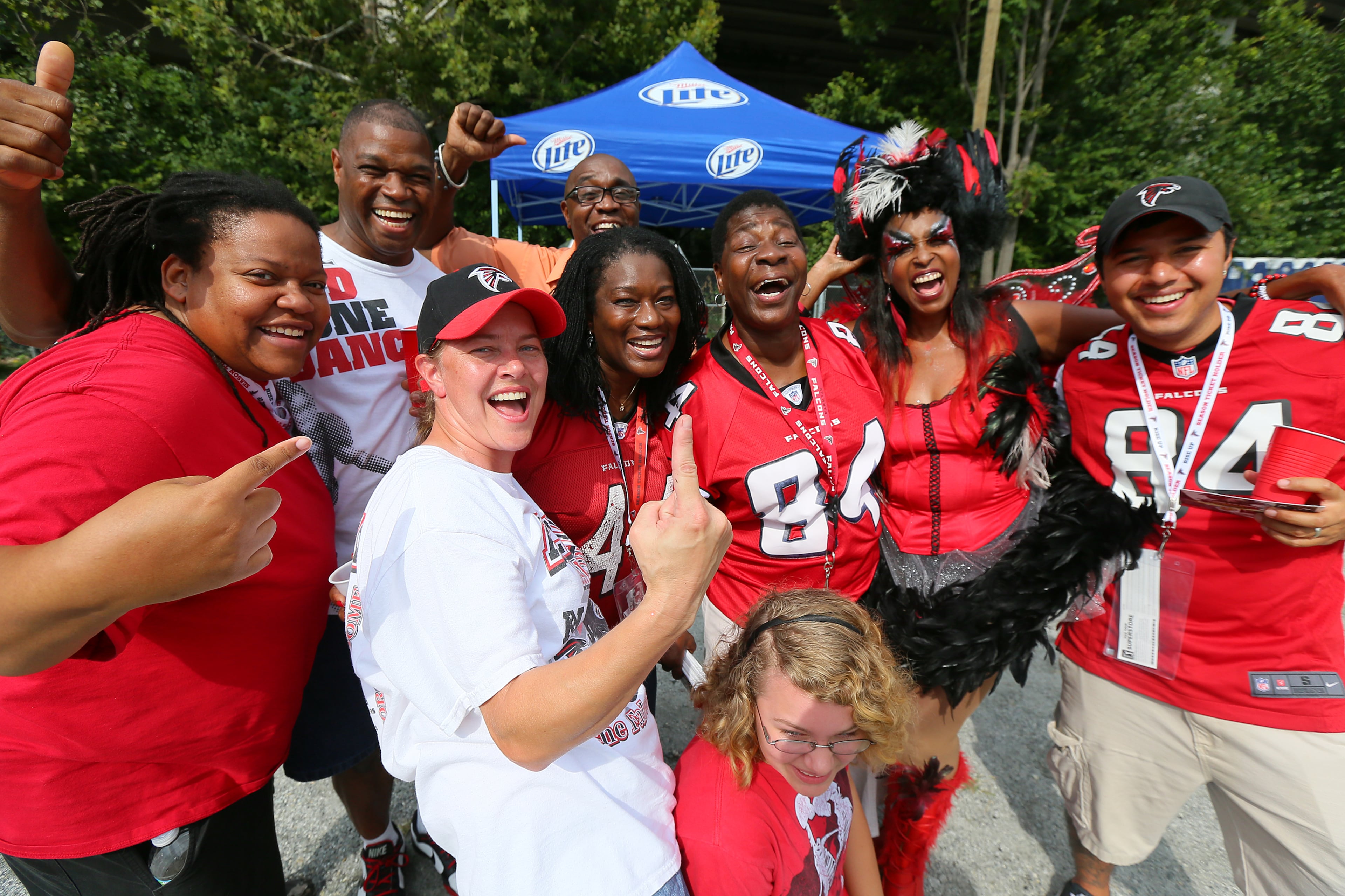 Members of "The Nest" tailgators get their game on to start the season before the Falcons NFL exhibition game against the Cincinnati Bengals on Thursday, August 8, 2013, in Atlanta.