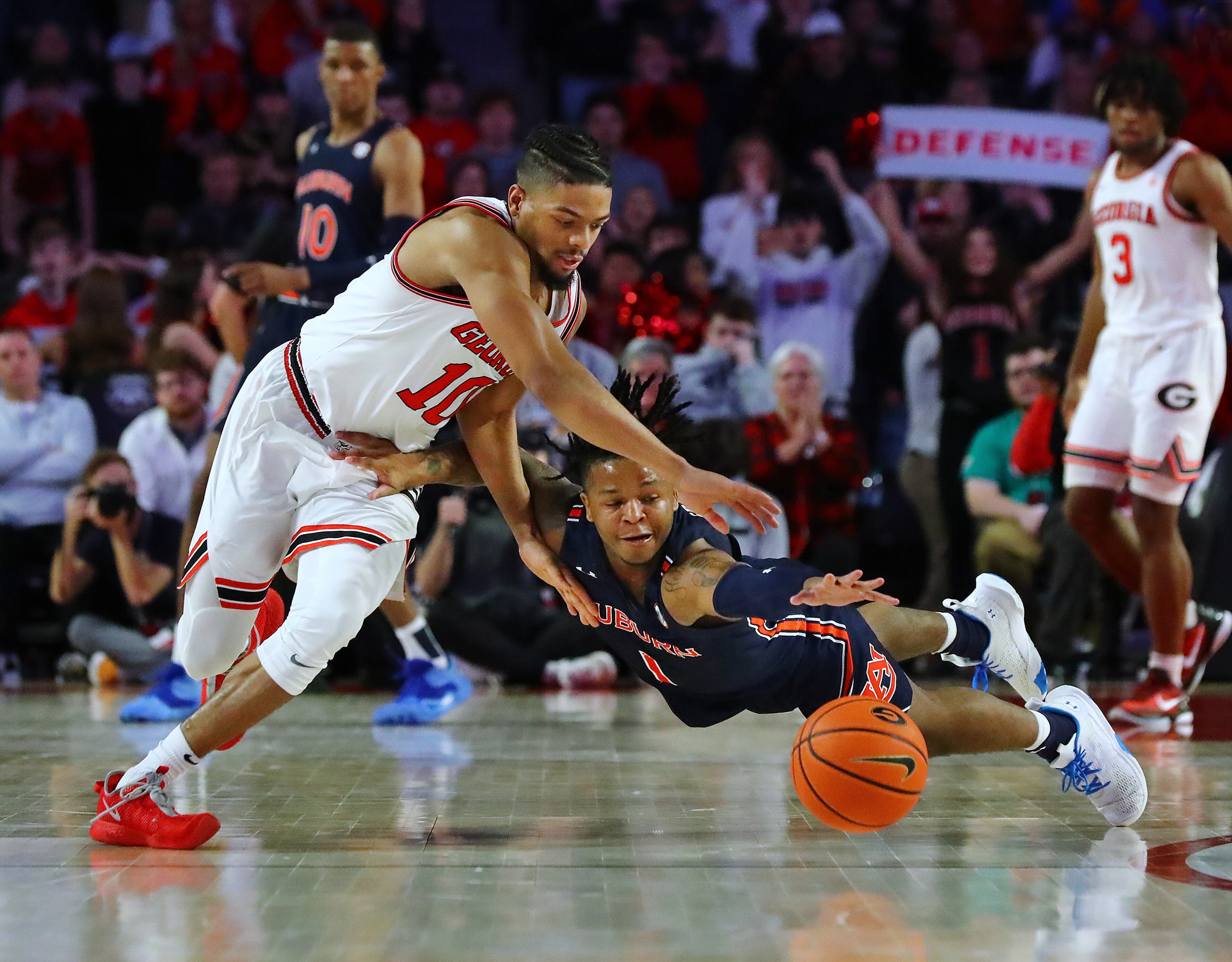 Georgia's Aaron Cook and Auburn's Wendell Green Jr. battle for a loose ball with Cook attempting a steal in a NCAA college basketball game on Saturday, Feb. 5, 2022, in Athens. “Curtis Compton / Curtis.Compton@ajc.com”`