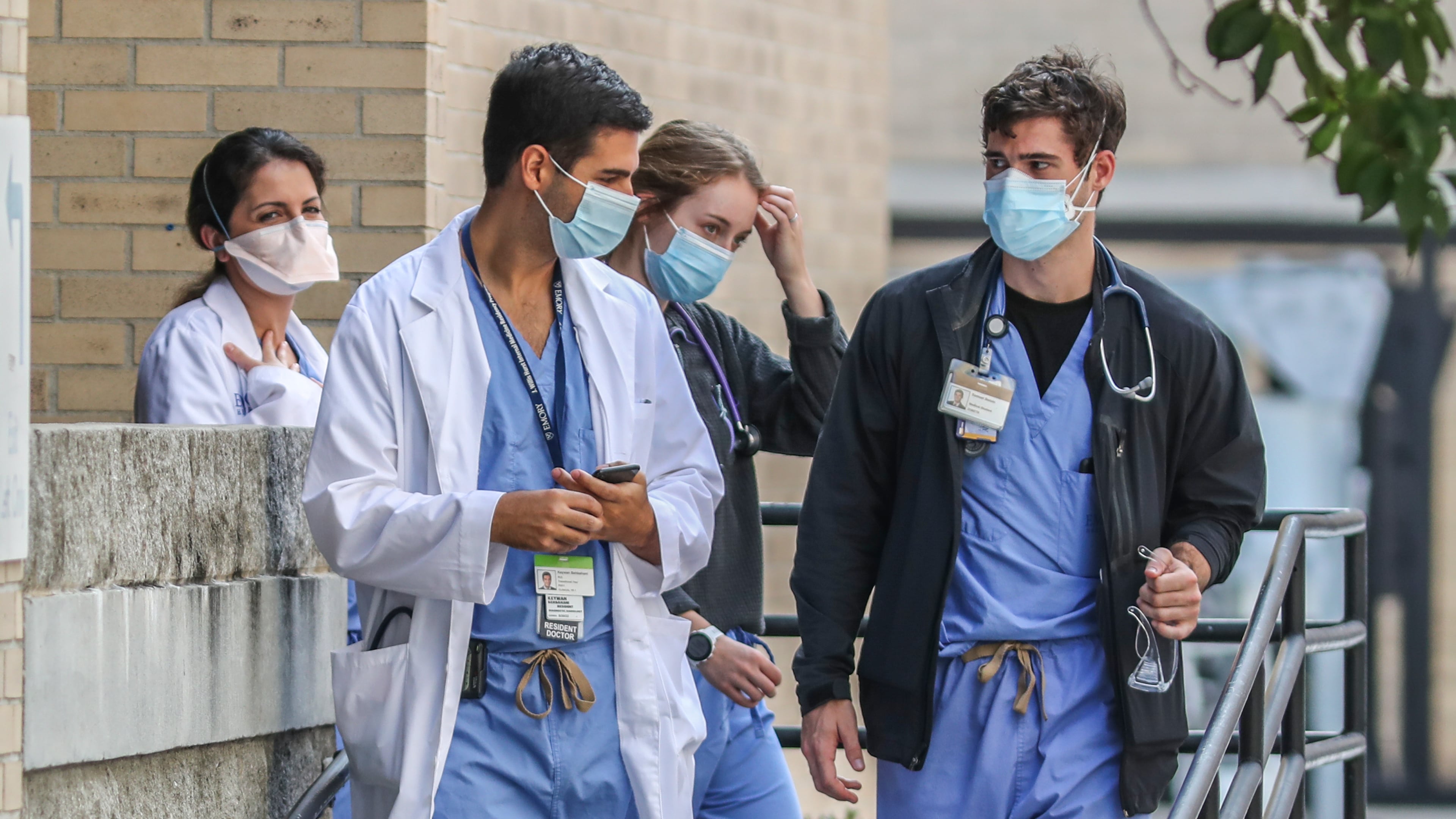 Medical workers move between buildings at Grady Memorial Hospital in downtown Atlanta on Thursday, Aug. 26, 2021. (John Spink / John.Spink@ajc.com)