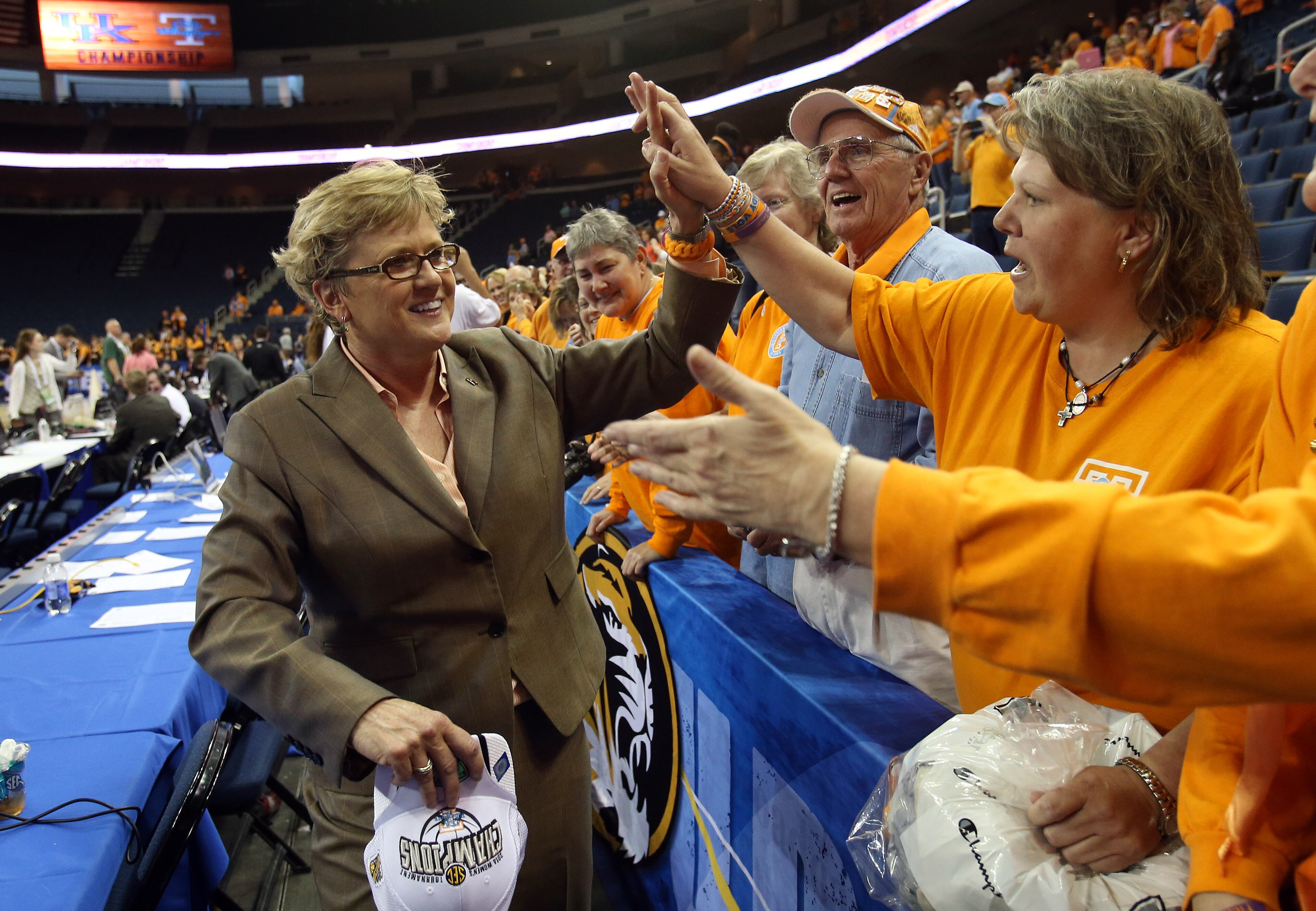 Tennessee head coach Holly Warlick, left, celebrates with fans after defeating Kentucky 71-70 in an NCAA college basketball game in the finals of the Southeastern Conference women's tournament on Sunday, March 9, 2014, in Duluth, Ga. (AP Photo/Jason Getz)