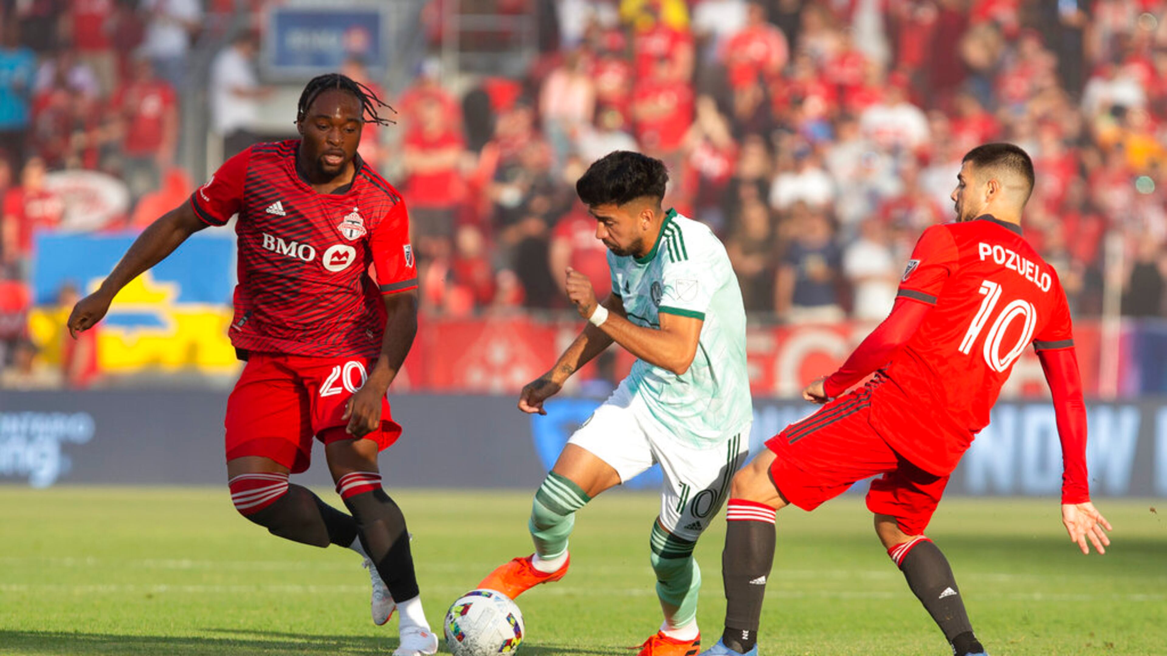 Atlanta United midfielder Marcelino Moreno, center, takes the ball between Toronto FC forward Ayo Akinola and midfielder Alejandro Pozuelo, right, during the first half of an MLS soccer match Saturday, June 25, 2022, in Toronto. (Chris Young/The Canadian Press via AP)
