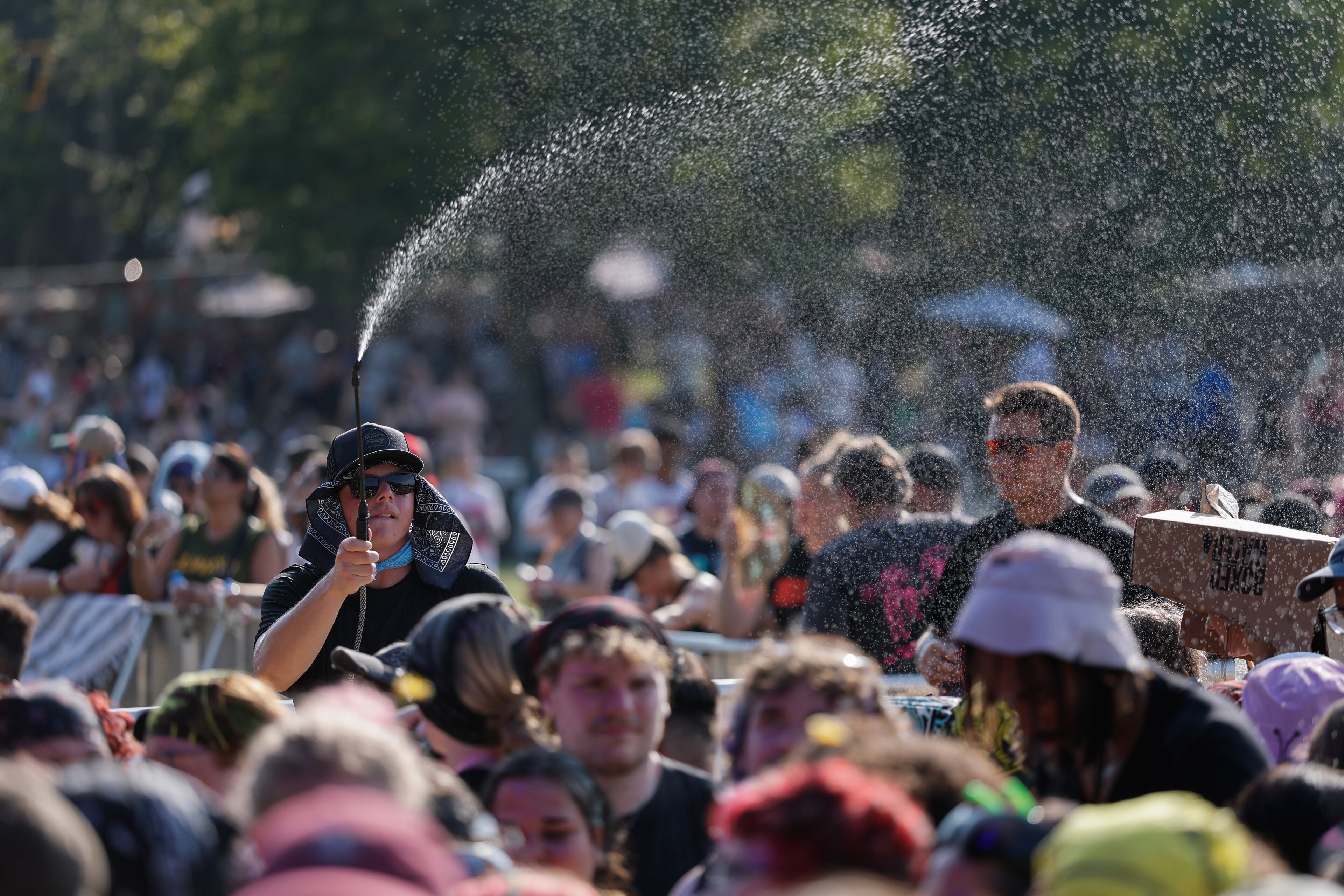 Fans try to keep cool as Peach Pit performs during the Shaky Knees music festival at Piedmont Park, Saturday, Sept. 19, 2026, in Atlanta. (Erik S. Lesser for the AJC)