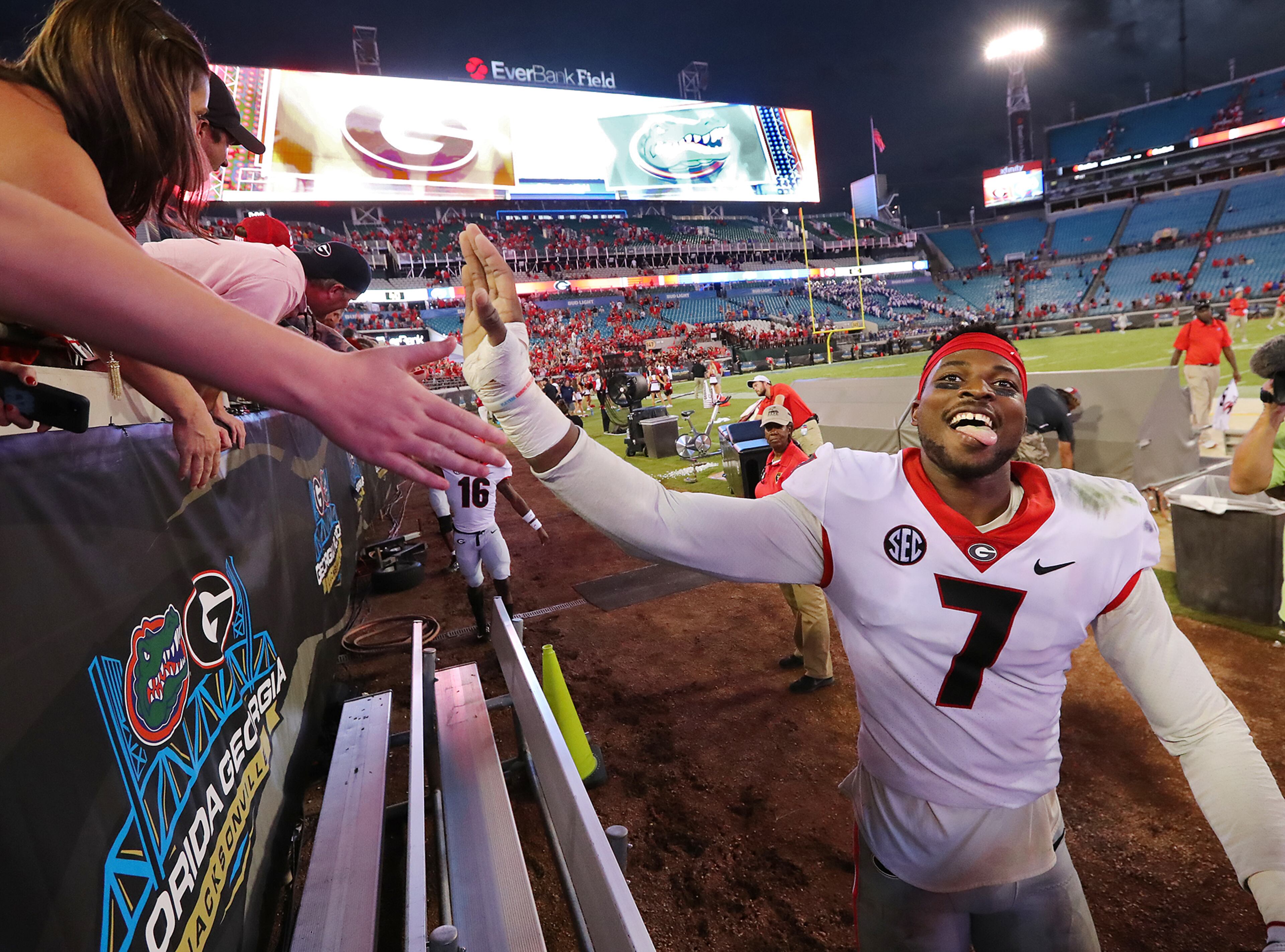 October 28, 2017 Jacksonville: Georgia linebacker Lorenzo Carter celebrates a 42-7 victory over Florida with fans in a NCAA college football game on Friday, October 27, 2017, in Jacksonville. Georgia beat Florida 42-7. Curtis Compton/ccompton@ajc.com