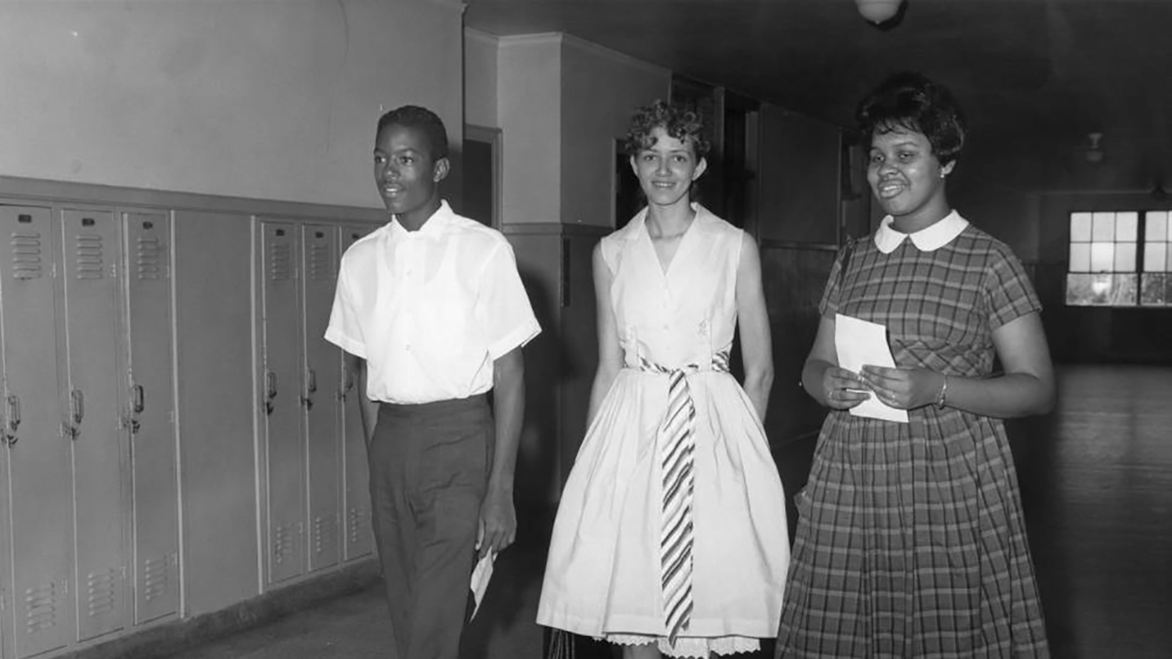 The three students selected to integrate Brown High School walk down the hall, possibly on registration day. Atlanta complied with school desegregation seven years after the Brown decision, and carefully managed how the first day of integration would roll out. (Bill Wilson / AJC Archive at the GSU Library AJCP297-004a)