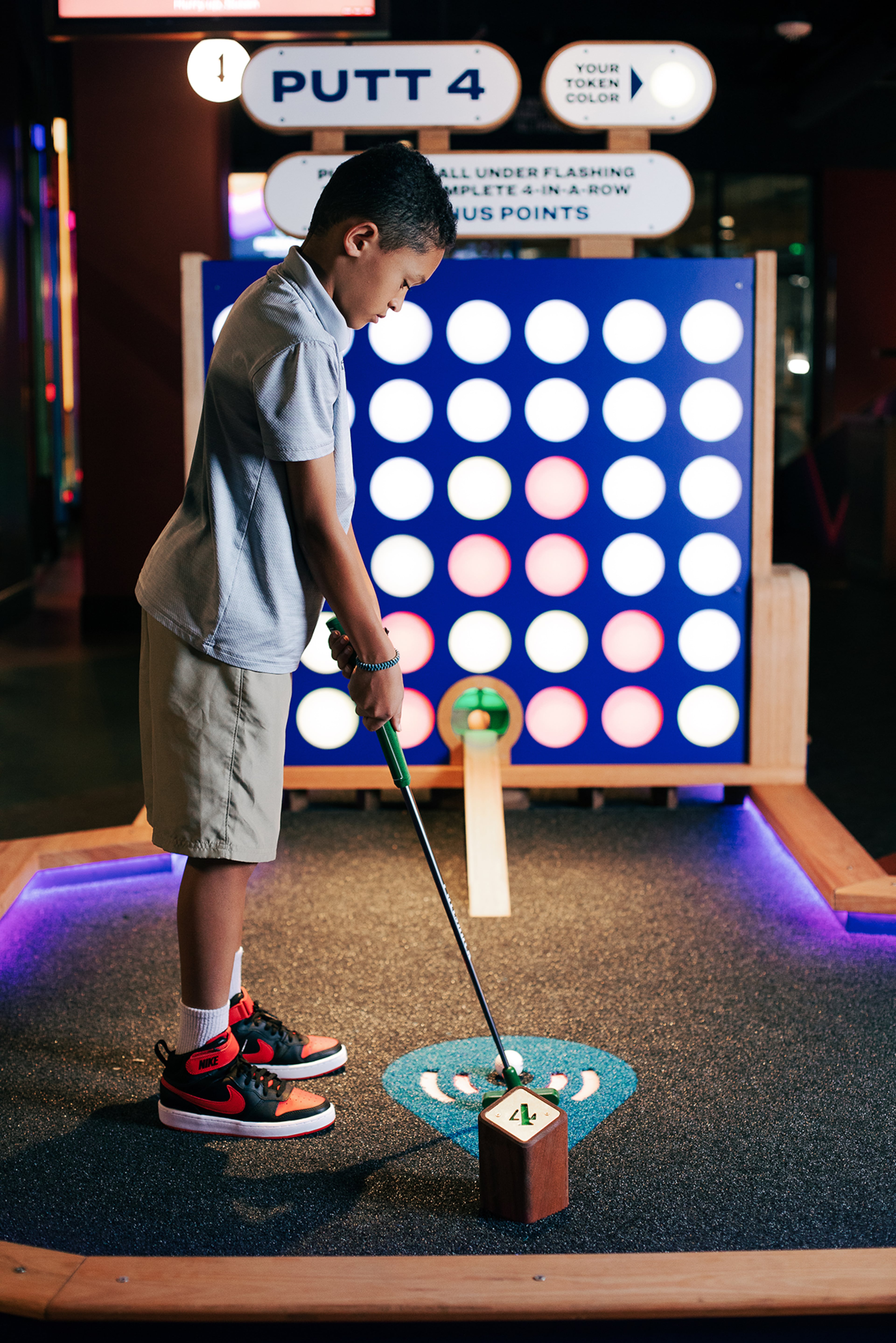 At Puttshack -- Atlanta, a youngster makes sure he’s set for the swing.
(Courtesy of Puttshack)