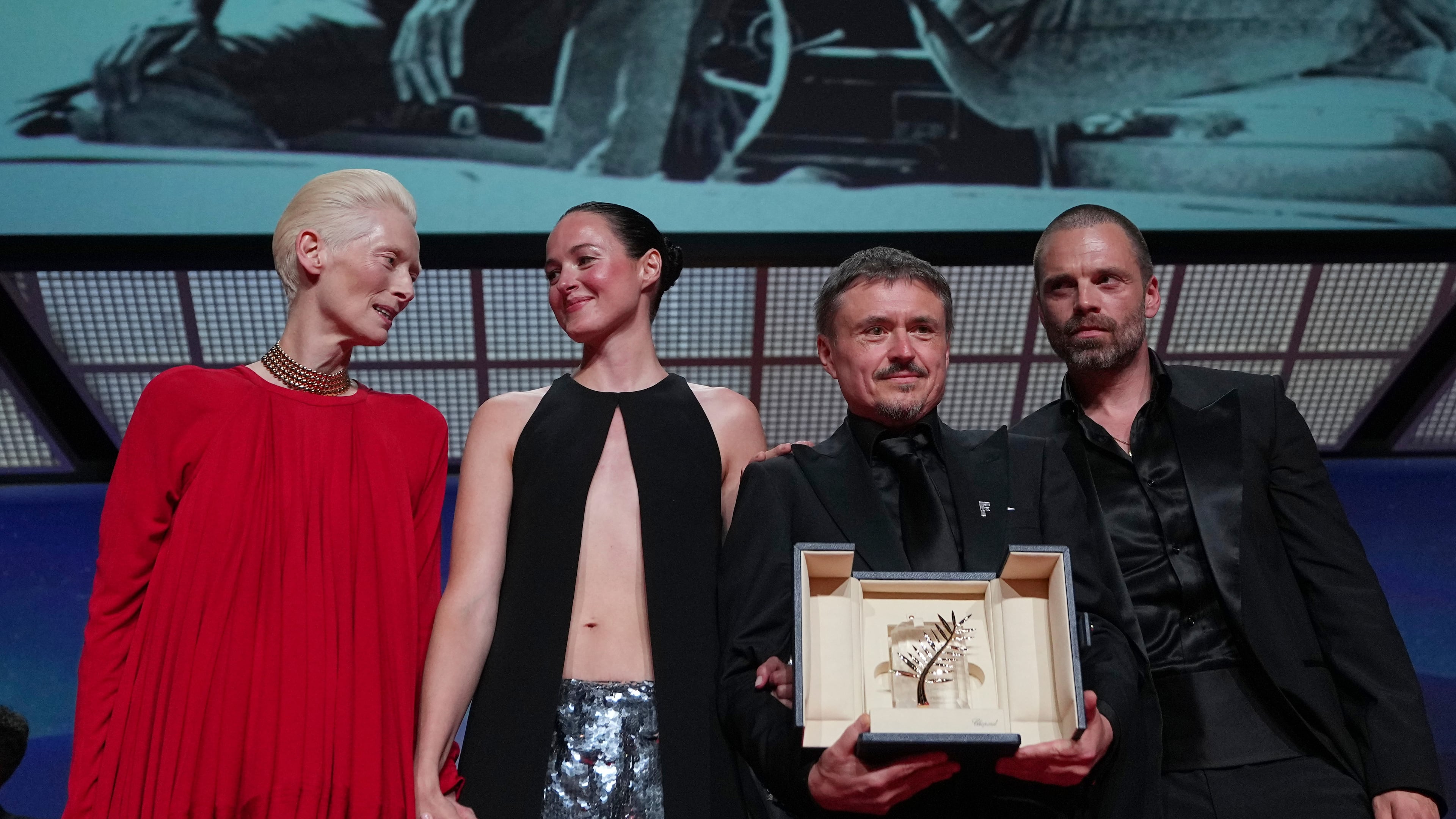 Tilda Swinton, left, poses with Renate Reinsve, Cristian Mungiu, winner of the Palme d'Or for 'Fjord' and Sebastian Stan during the awards ceremony at the 79th international film festival, Cannes, southern France, Saturday, May 23, 2026. (AP Photo/Andreea Alexandru)