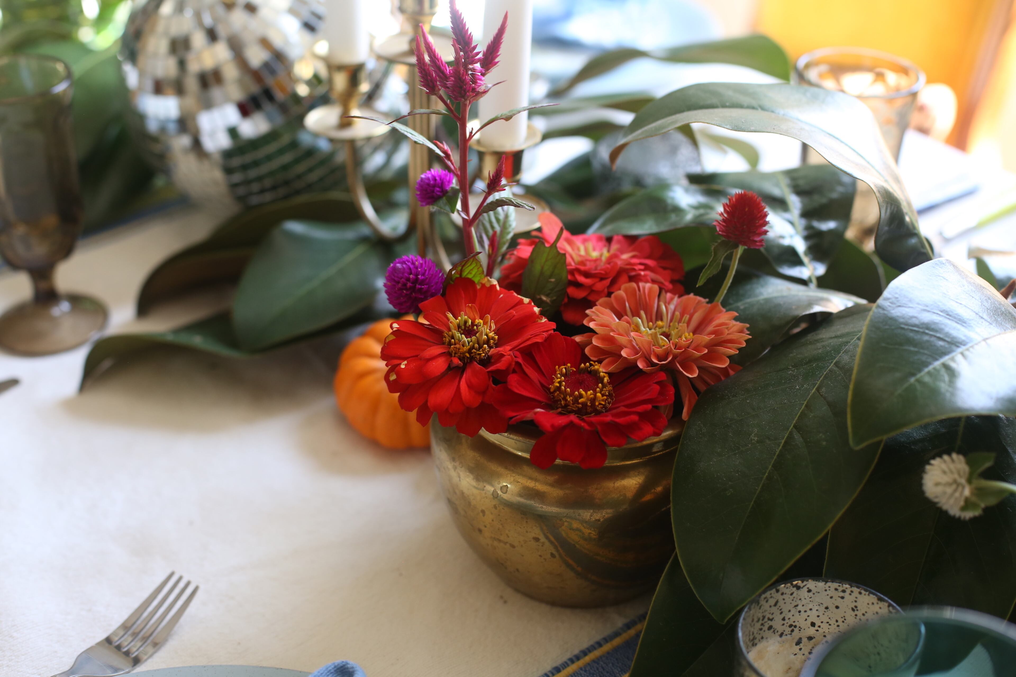 For her dining table centerpiece, Augusta Wheeler used magnolia leaves from her yard and organic wildflowers from Evan Neal with Chattahoochee Queen, a vendor at the Grant Park Farmers Market.