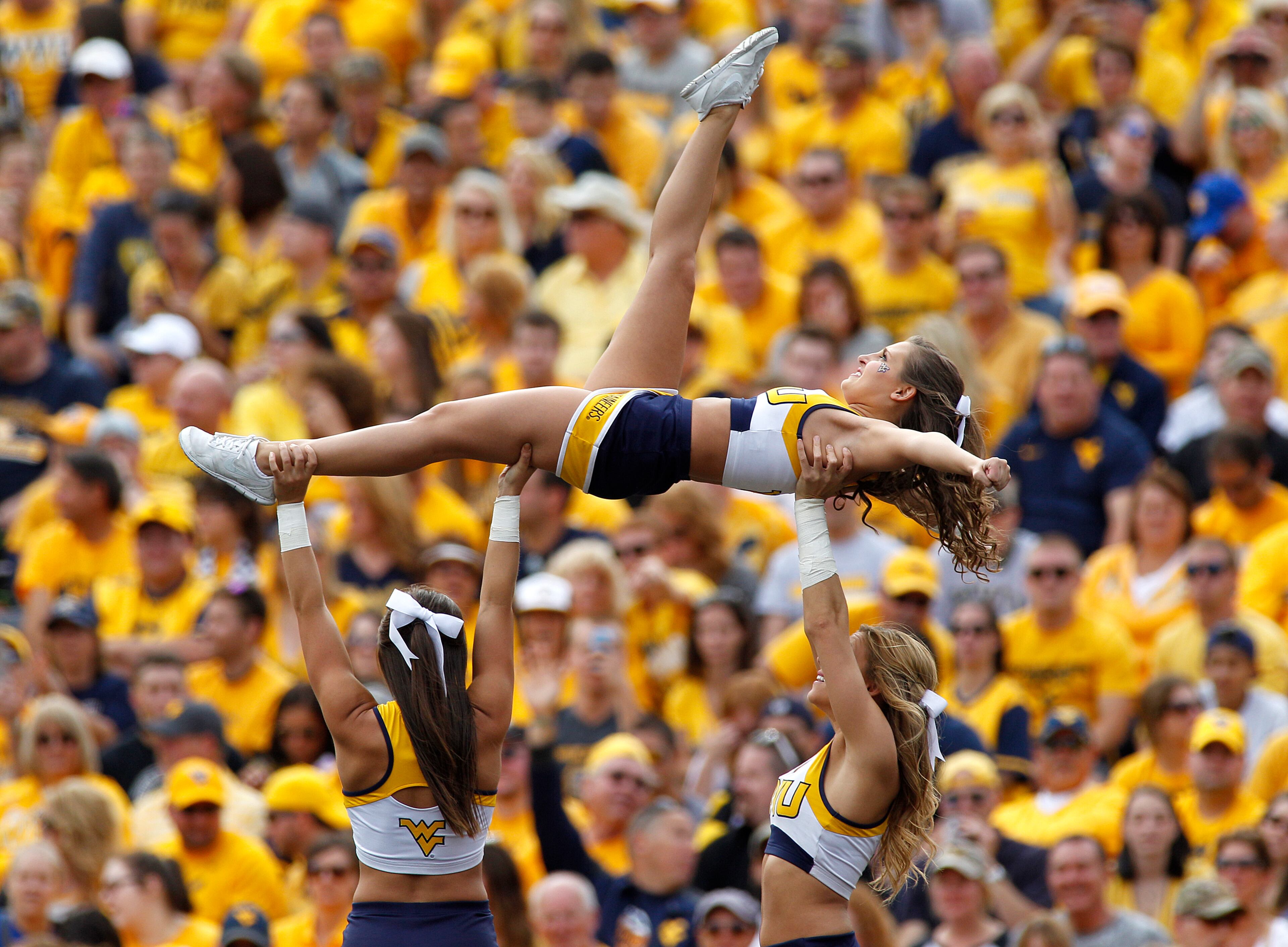 West Virginia Mountaineers cheerleaders perform during the game against the Maryland Terrapins on September 26, 2015 at Mountaineer Field in Morgantown, West Virginia. (Photo by Justin K. Aller/Getty Images)