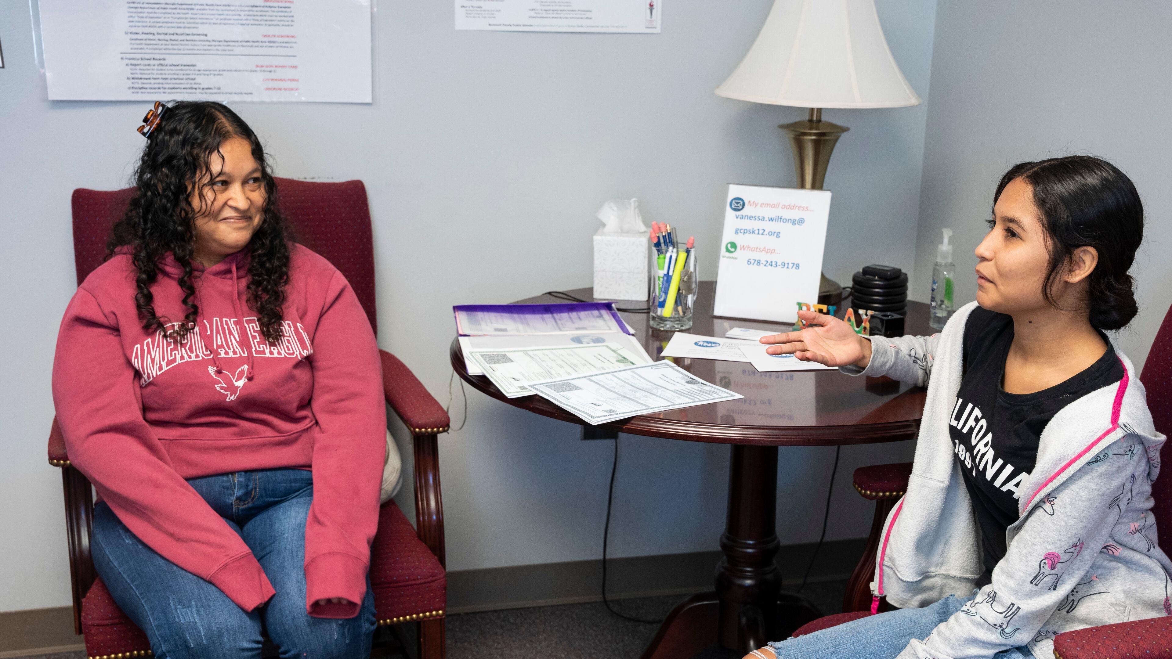 Martha Alicia Jimenez Zarco (left) and her daughter Blanca Estela Torres Jimenez (right) meet with advisers at the International Newcomer Center to fill out paperwork to enroll in the Gwinnett County school system on Monday, Oct. 9, 2023. (Olivia Bowdoin for The Atlanta Journal-Constitution)