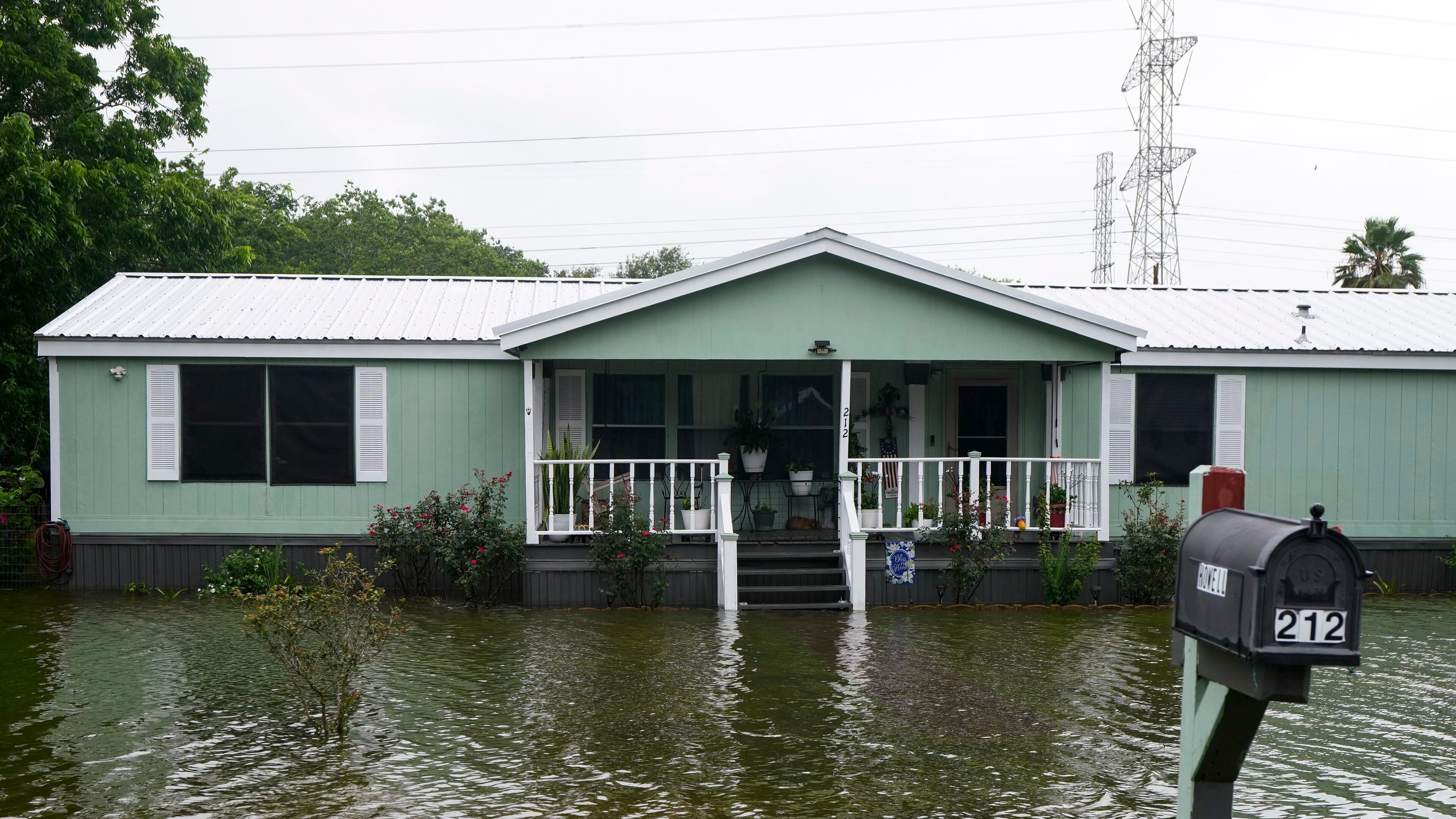 Water surrounds homes in the aftermath of Tropical Storm Arthur in rural Brazoria County, Texas, Wednesday, June 17, 2026. (Brett Coomer/Houston Chronicle via AP)