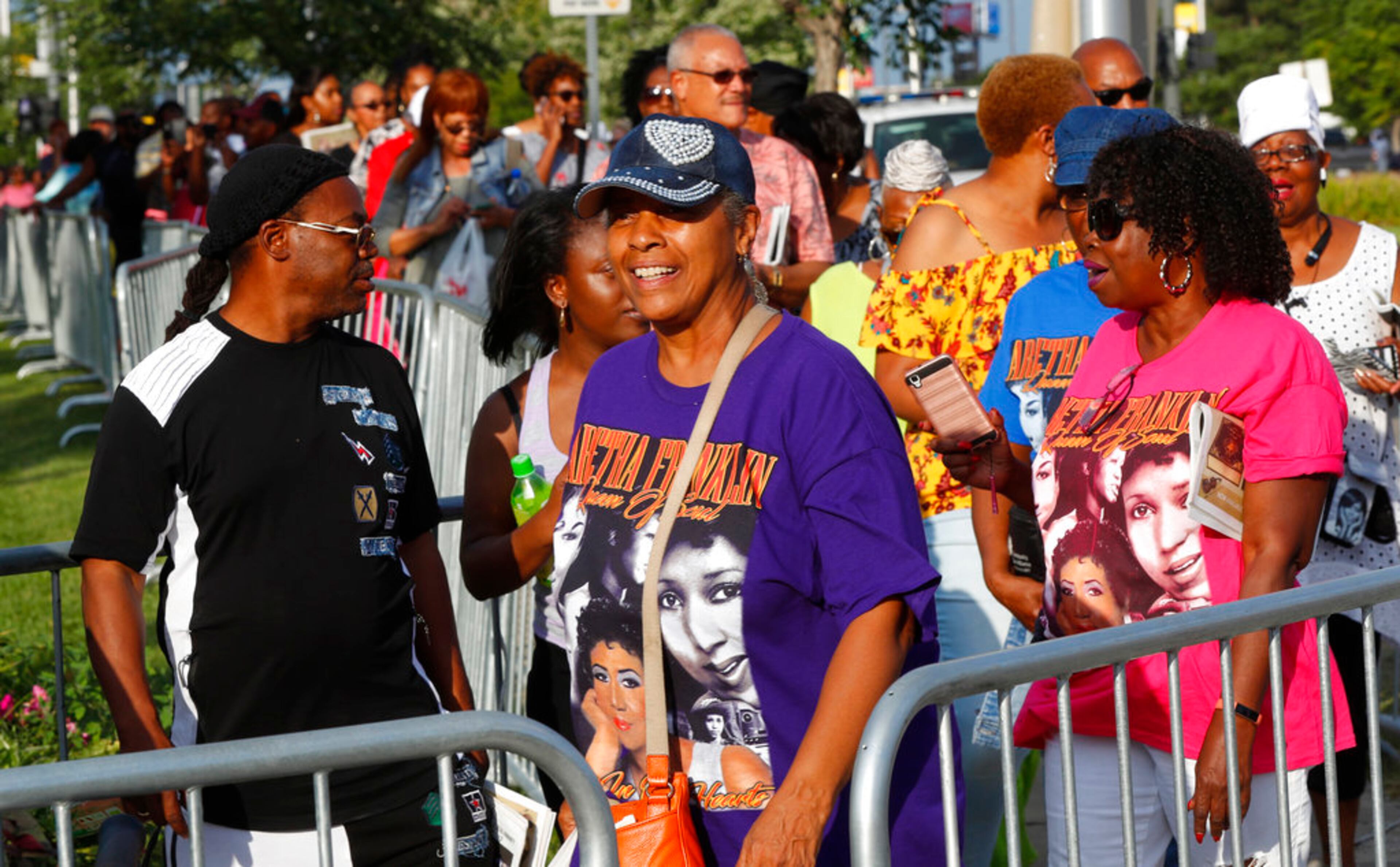 People wait in line outside the Charles H. Wright Museum of African American History during a public visitation for legendary singer Aretha Franklin in Detroit, Tuesday, Aug. 28, 2018. Franklin died Aug. 16, 2018 of pancreatic cancer at the age of 76. (AP Photo/Paul Sancya)