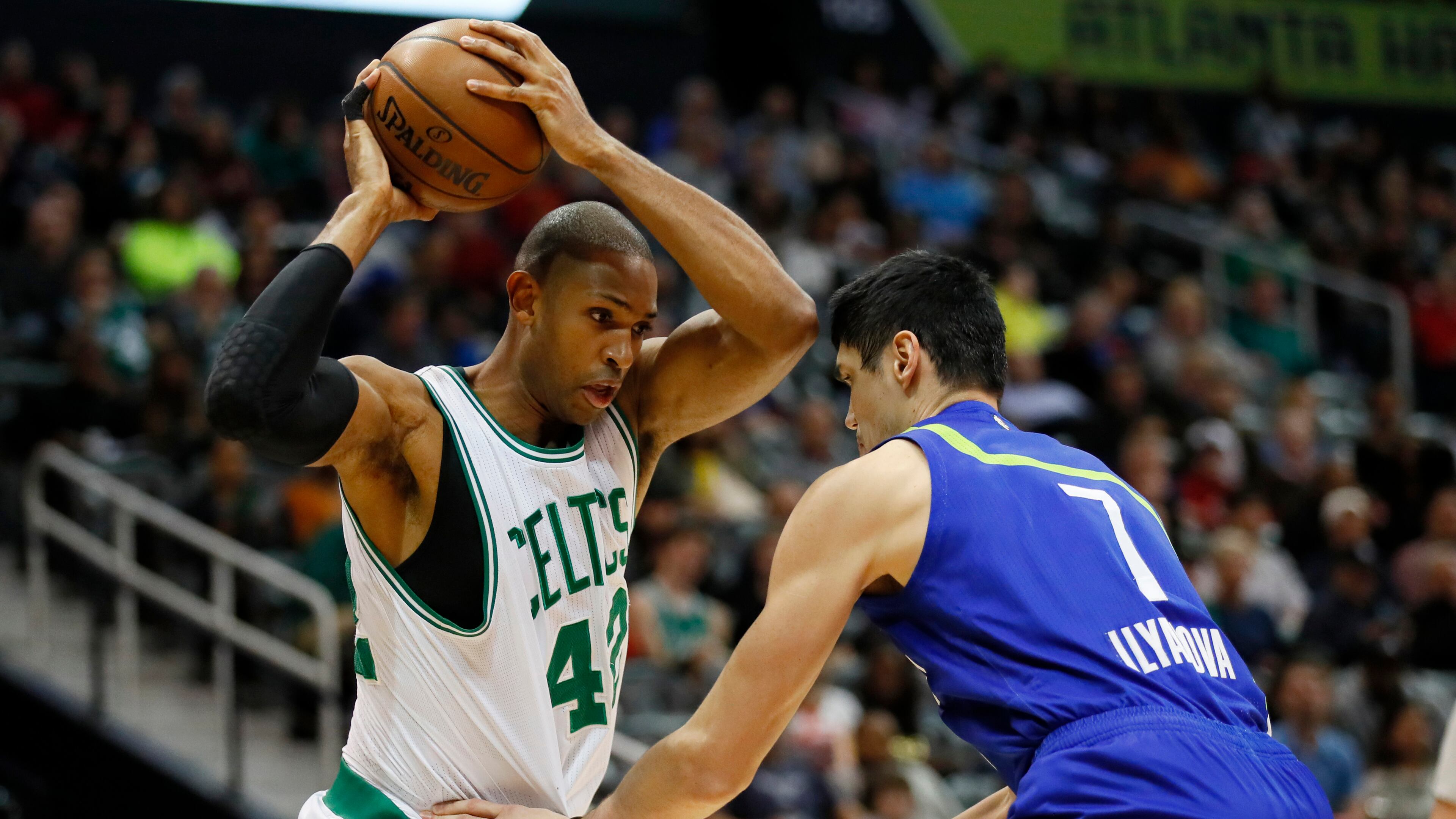 Boston Celtics center Al Horford (42) looks to pass around Atlanta Hawks forward Ersan Ilyasova (7) in the first half of an NBA basketball game on Thursday, April 6, 2017, in Atlanta. (AP Photo/Todd Kirkland)