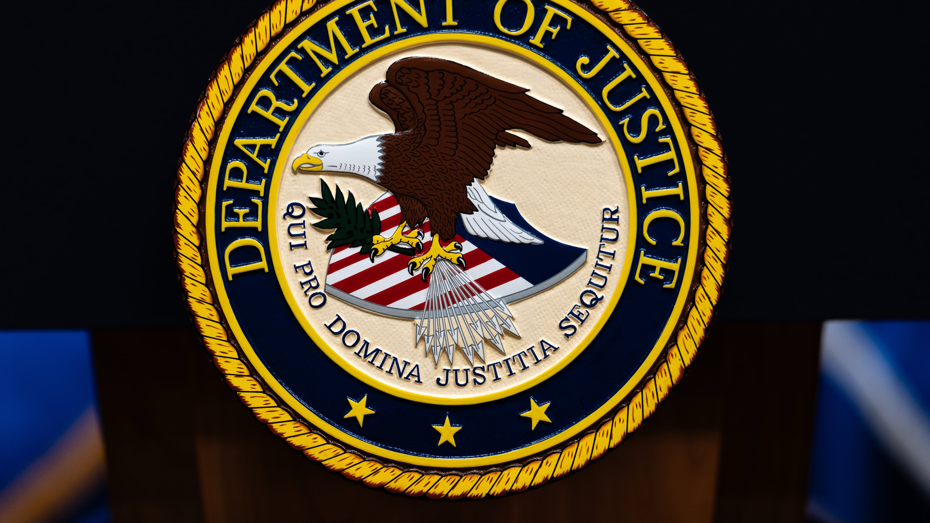 FILE - The U.S. Department of Justice logo is seen on a podium before a news conference, May 4, 2026, in Washington. (AP Photo/Julia Demaree Nikhinson, File)