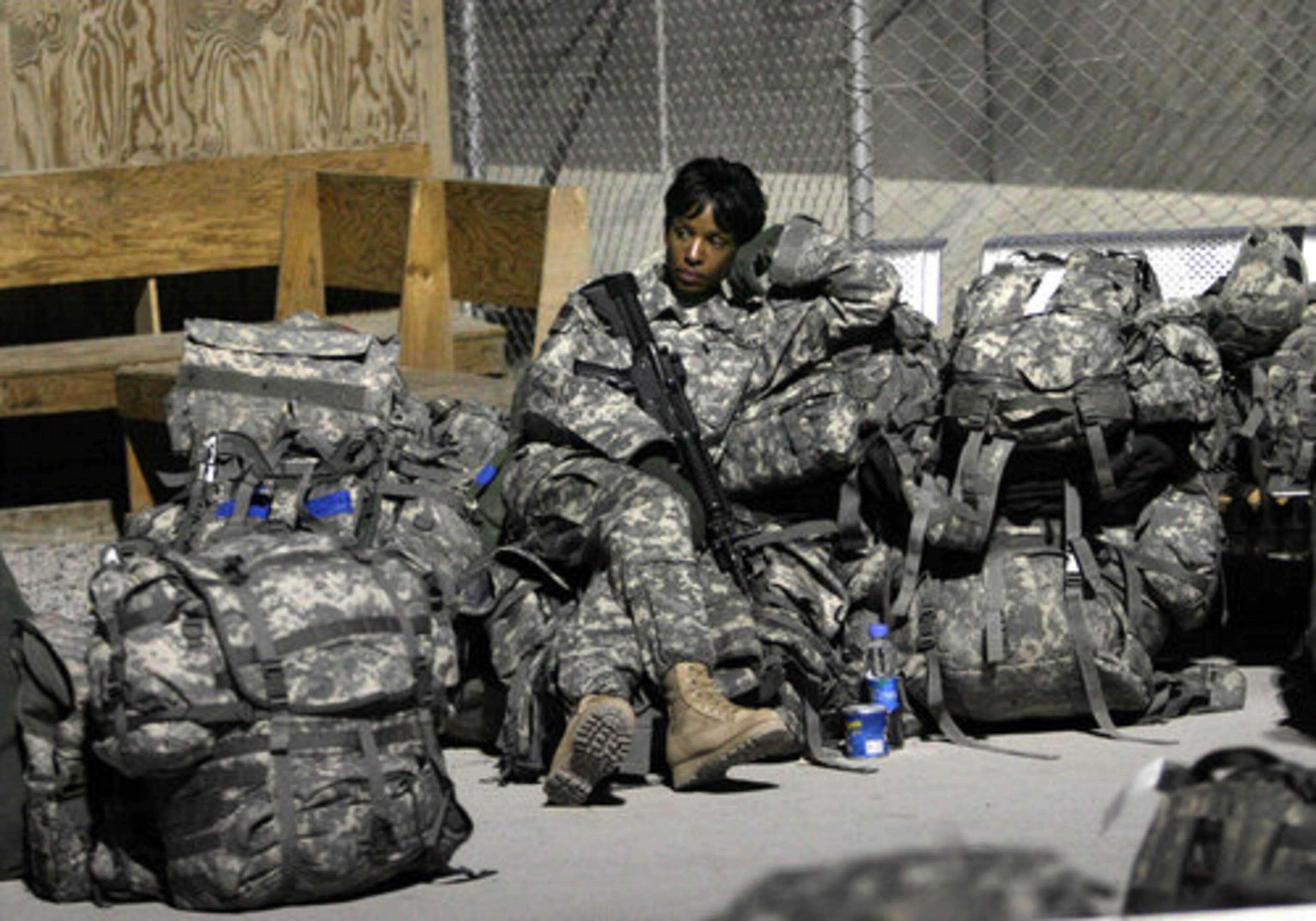 A U.S. soldier waits for her flight at the airfield in Kandahar province south of Kabul.