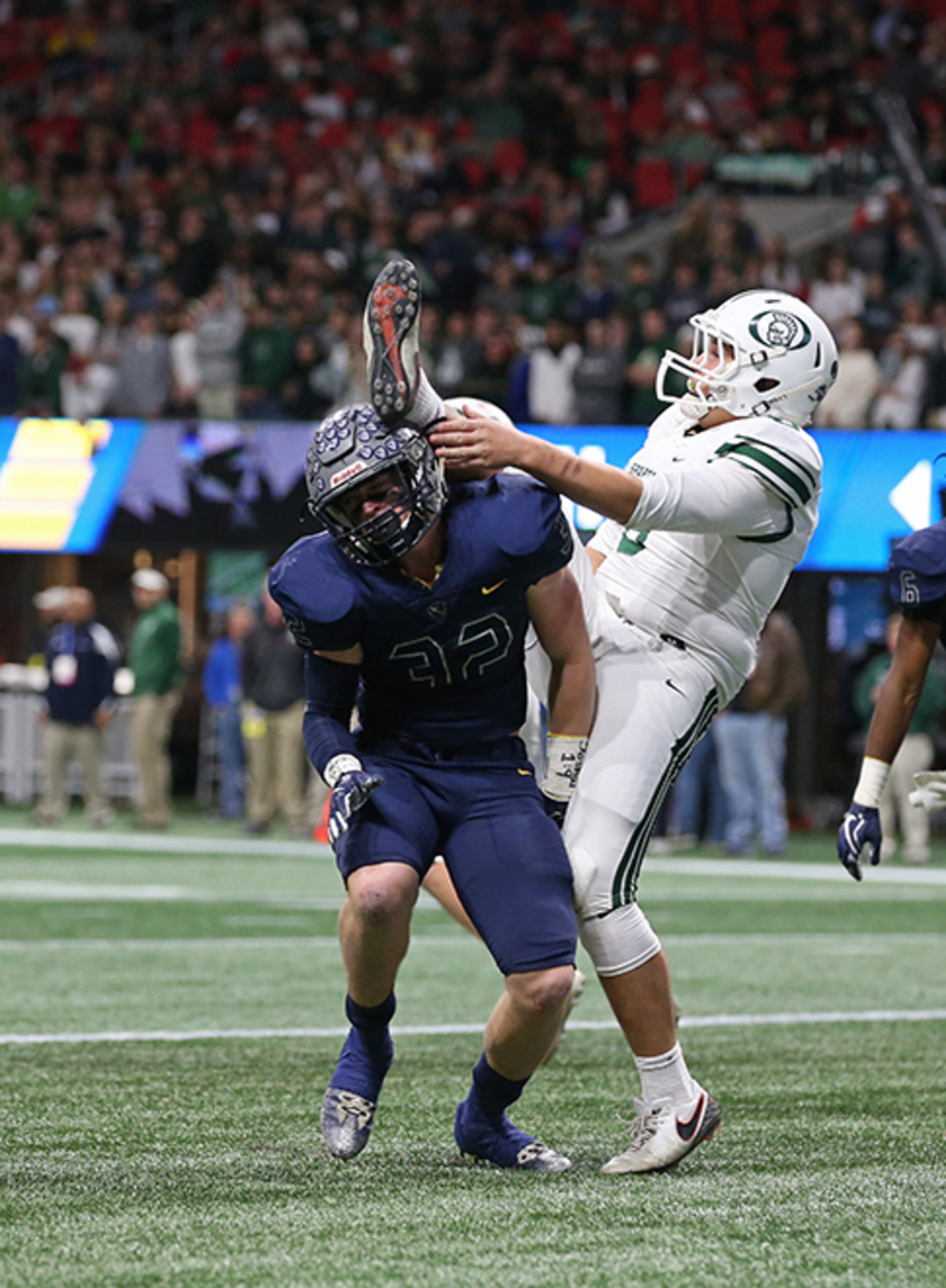 Eagle's Landing Christian linebacker George Shockley (32) runs into Athens Academy punter Charlie King (6) in the first half during the Class A Private Championship Friday, Dec. 8, 2017, at Mercedes-Benz Stadium in Atlanta.