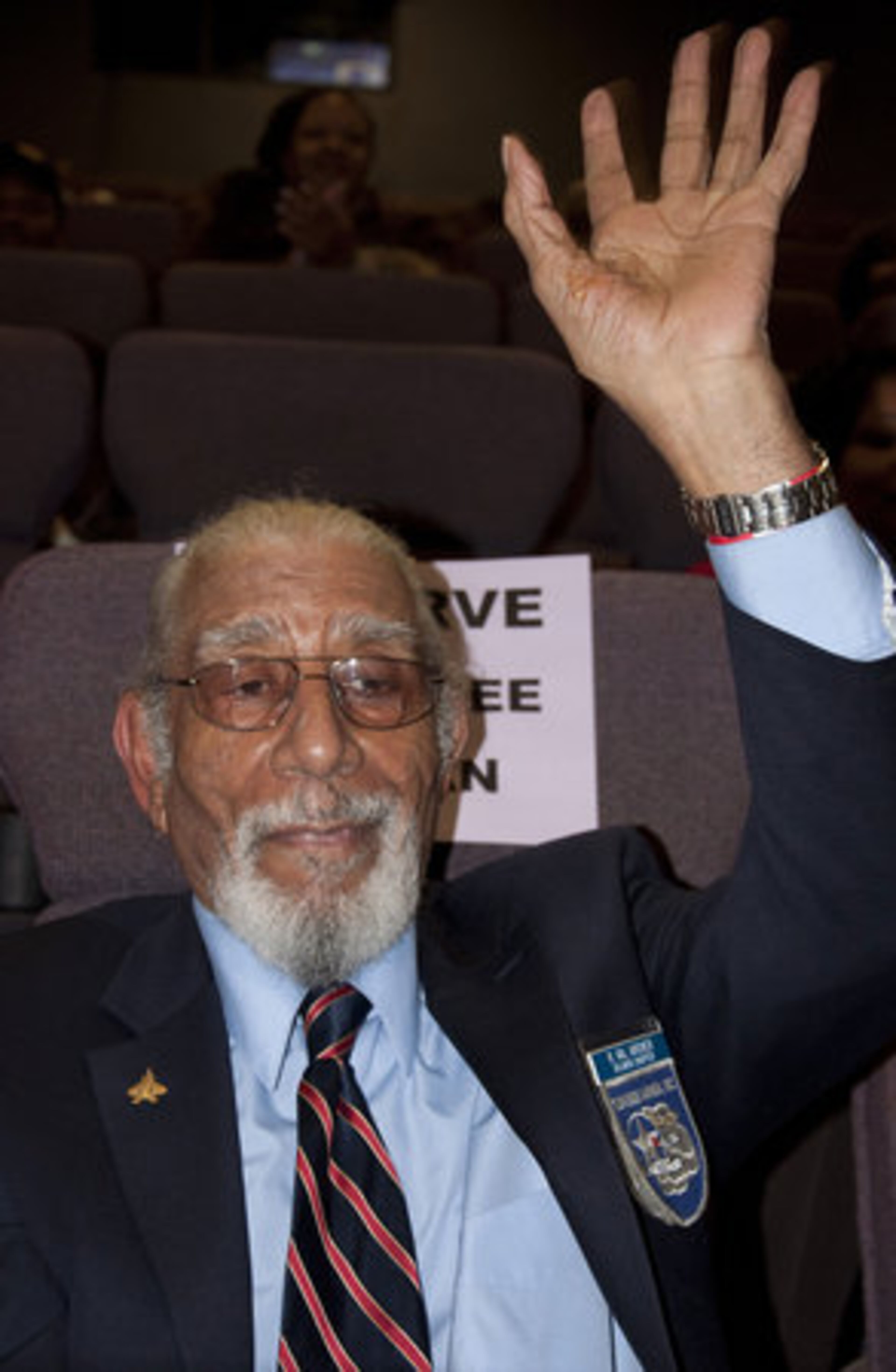 Atlanta Tuskegee Airmen Val Archer waves to the crowd during introductions.