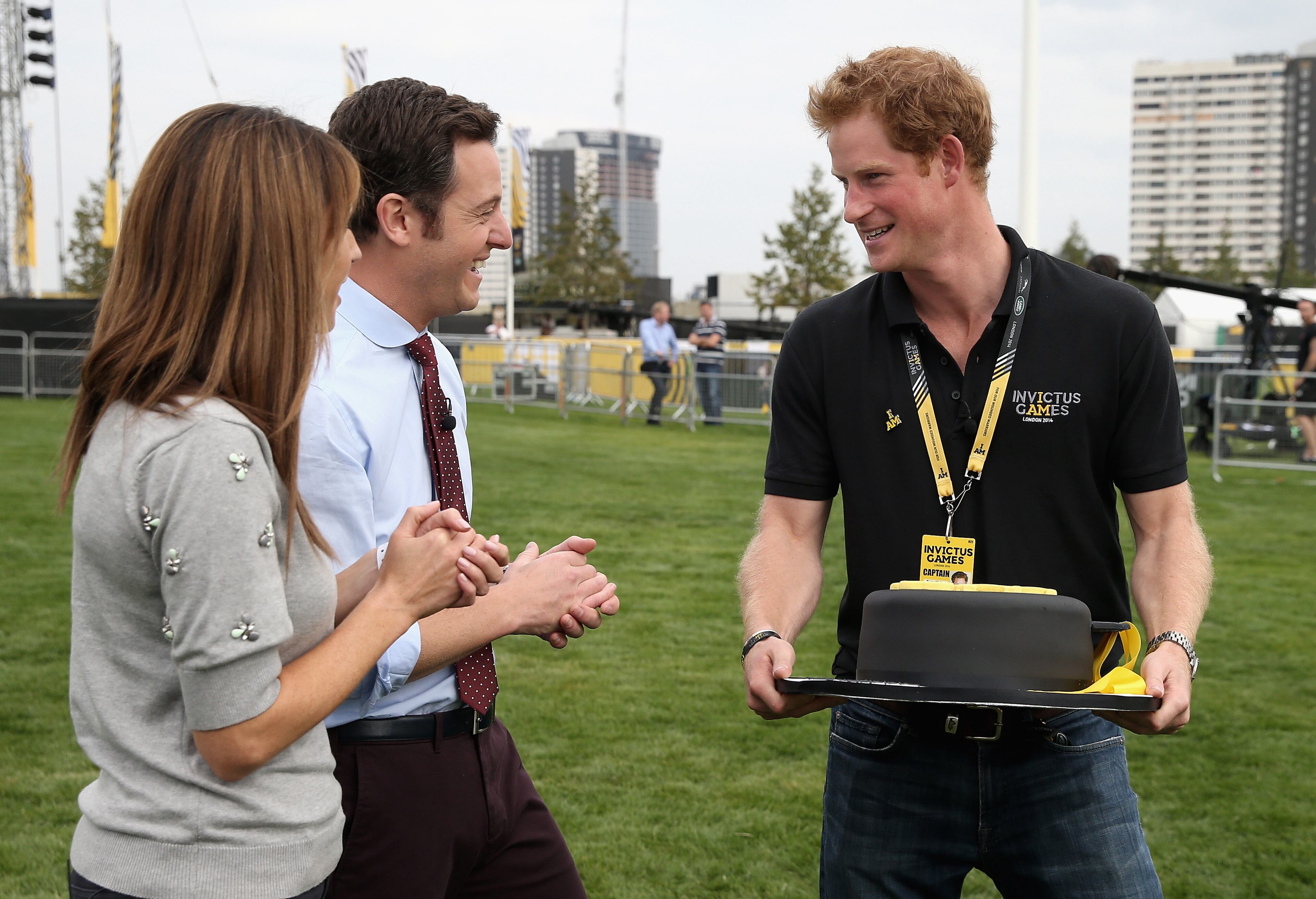 LONDON, ENGLAND - SEPTEMBER 11: Prince Harry is presented with a birthday cake by Alex Jones and Matt Baker of the One Show ahead of the Opening Ceremony of the Invictus Games at Queen Elizabeth park on September 11, 2014 in London, England. The International sports event for 'wounded warriors', presented by Jaguar Land Rover, is just days away with limited last-minute tickets available at www.invictusgames.org (Photo by Chris Jackson/Getty Images)