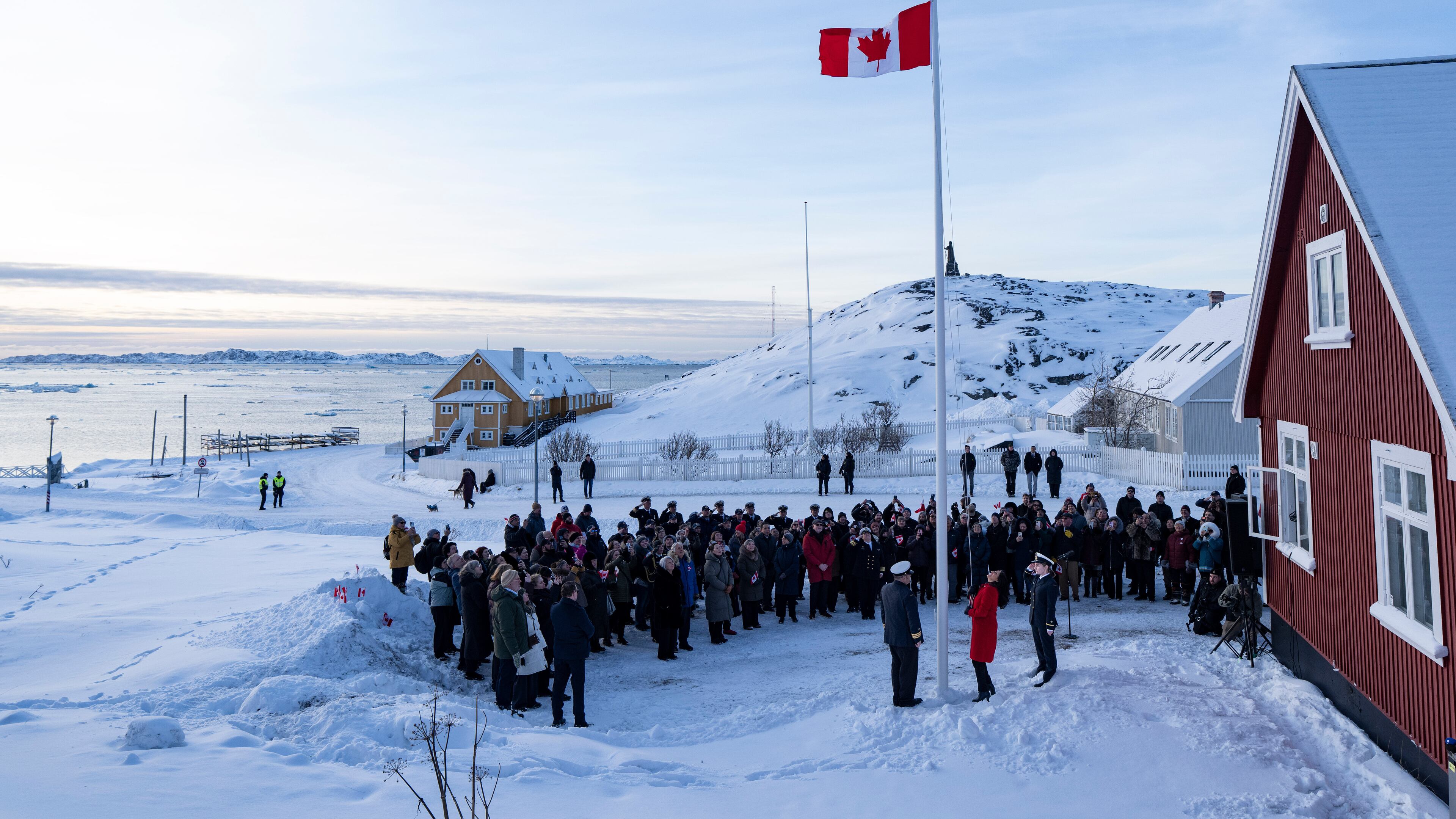 Foreign Affairs Minister Anita Anand, foreground center, helps raise the Canadian flag at the new Canadian consulate in Nuuk, Greenland, on Friday, Feb. 6, 2026. (Christinne Muschi/The Canadian Press via AP)