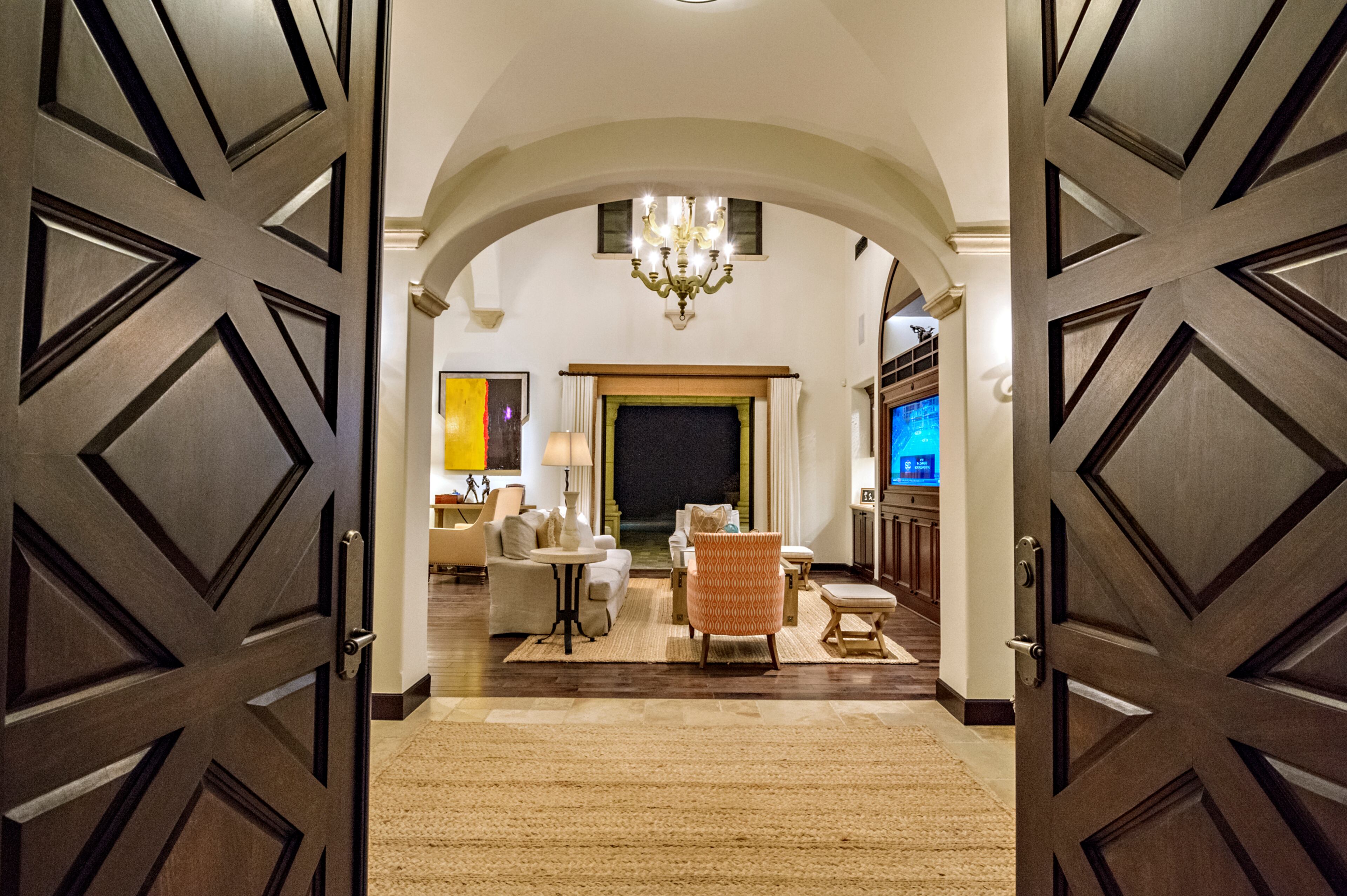 Heavy wood double doors open up to a vaulted ceiling in the entryway, which leads into the double-height living room. Rocky star and all-around action movie legend Sylvester Stallone has put his desert home in a gated La Quinta, Calif., community up for sale at $4.2 million. The 5,173-square-foot, four-bedroom, 4.5-bathroom home features details such as arched doorways, exposed beams, and plenty of space to hang his paintings, since he’s not just an actor—he’s an artist, too. Listing courtesy of Josh Reef, Hurwitz James Company
