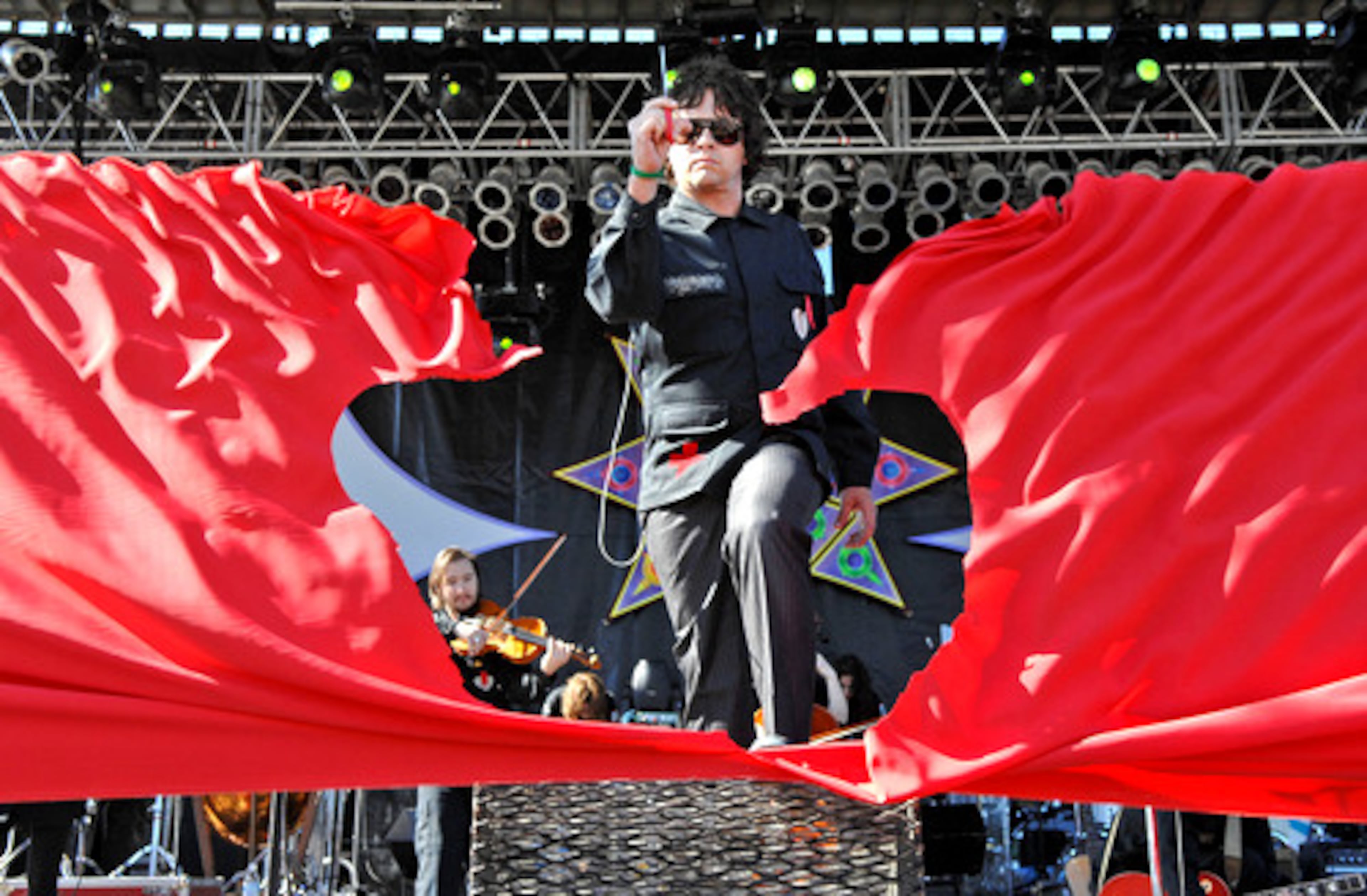 Tim DeLaughter, lead singer and band leader for Polyphonic Spree, cut a large red ribbon that signaled the start of the three-day, eco-centric Echo Project music festival.