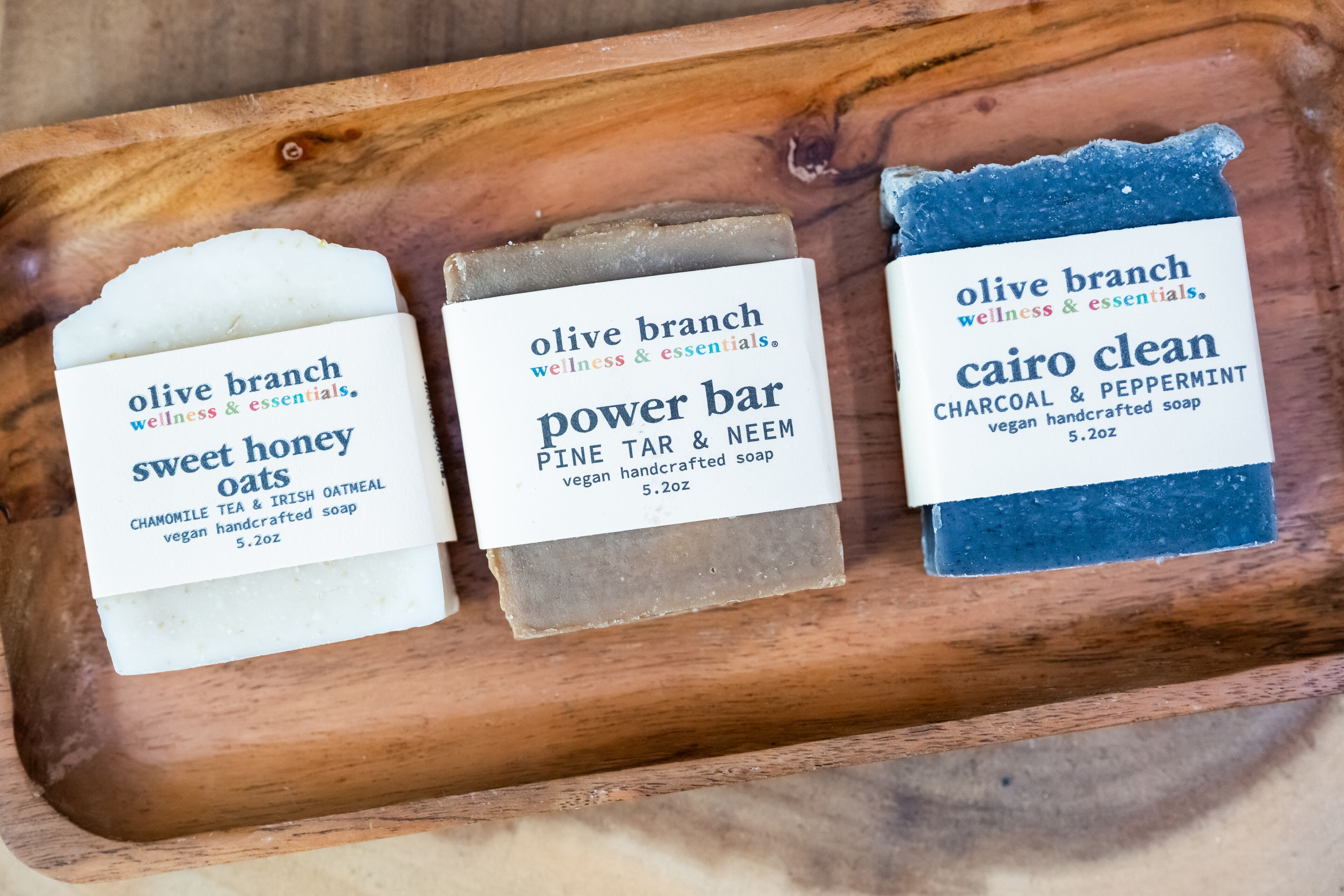 A trio of soaps — Sweet Honey Oats, Power Bar and Cairo Clean — at Olive Branch in downtown Decatur, April 29, 2025. (Bita Honarvar for the AJC)