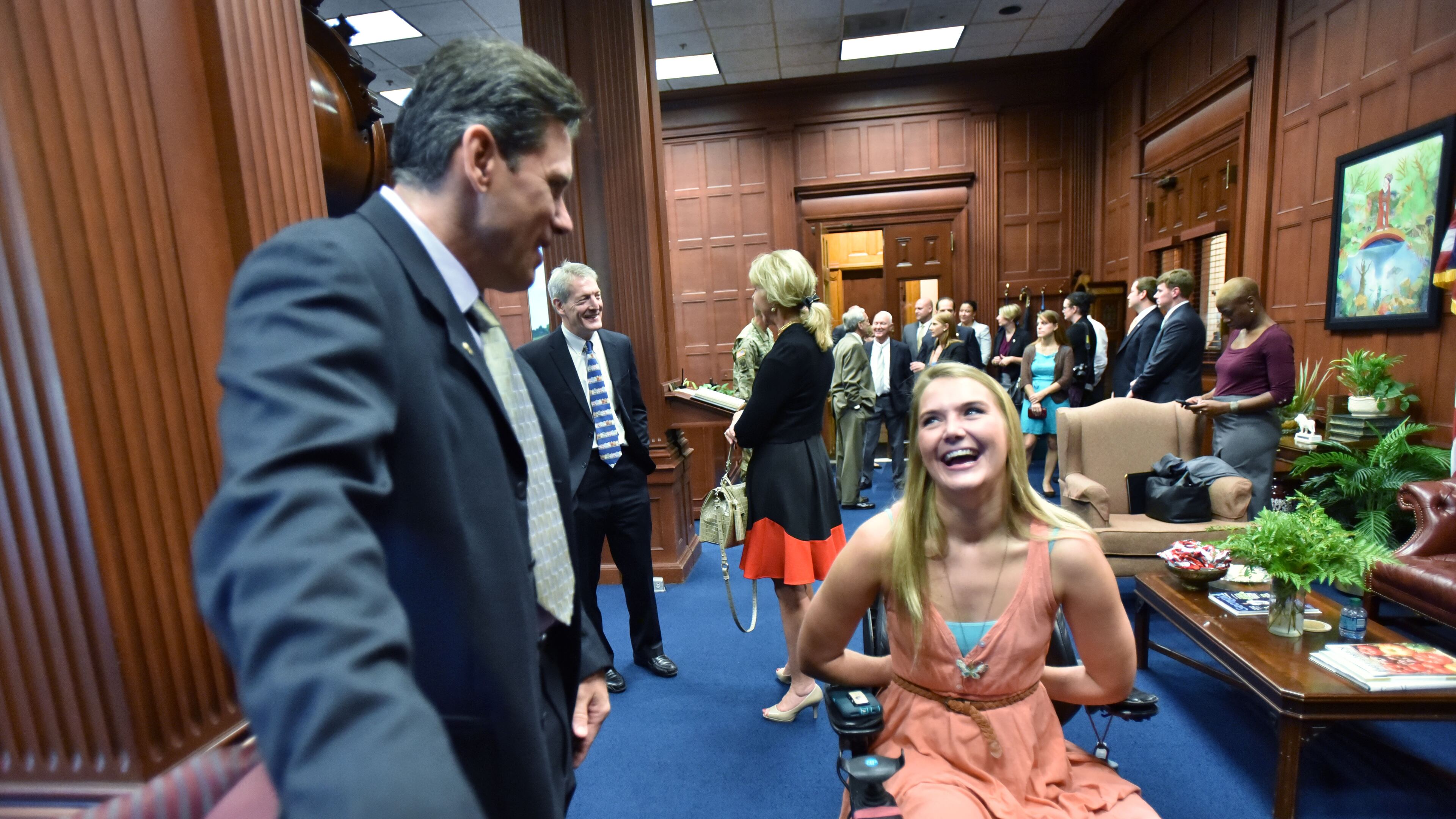 August 23, 2016 Atlanta - Aimee Copeland shares a smile with Chris Brand (left), president/CEO of Friends of Disabled Adults & Children, before they meet and take a picture with Gov. Nathan Deal at The Georgia State Capitol Tuesday morning, August 23, 2016. Personal Journey: Aimee Copeland was attending the University of West Georgia when, on May 1, 2012, she fell from a zipline running over the Little Tallapoosa River. Her left leg was gashed and left susceptible to necrotizing fasciitis, which threatened her life and led to amputations of both hands, her left leg and her right foot. Since then, she's completed Master's degrees in humanistic psychology and social work. She's also become an advocate for people with disabilities. HYOSUB SHIN / HSHIN@AJC.COM