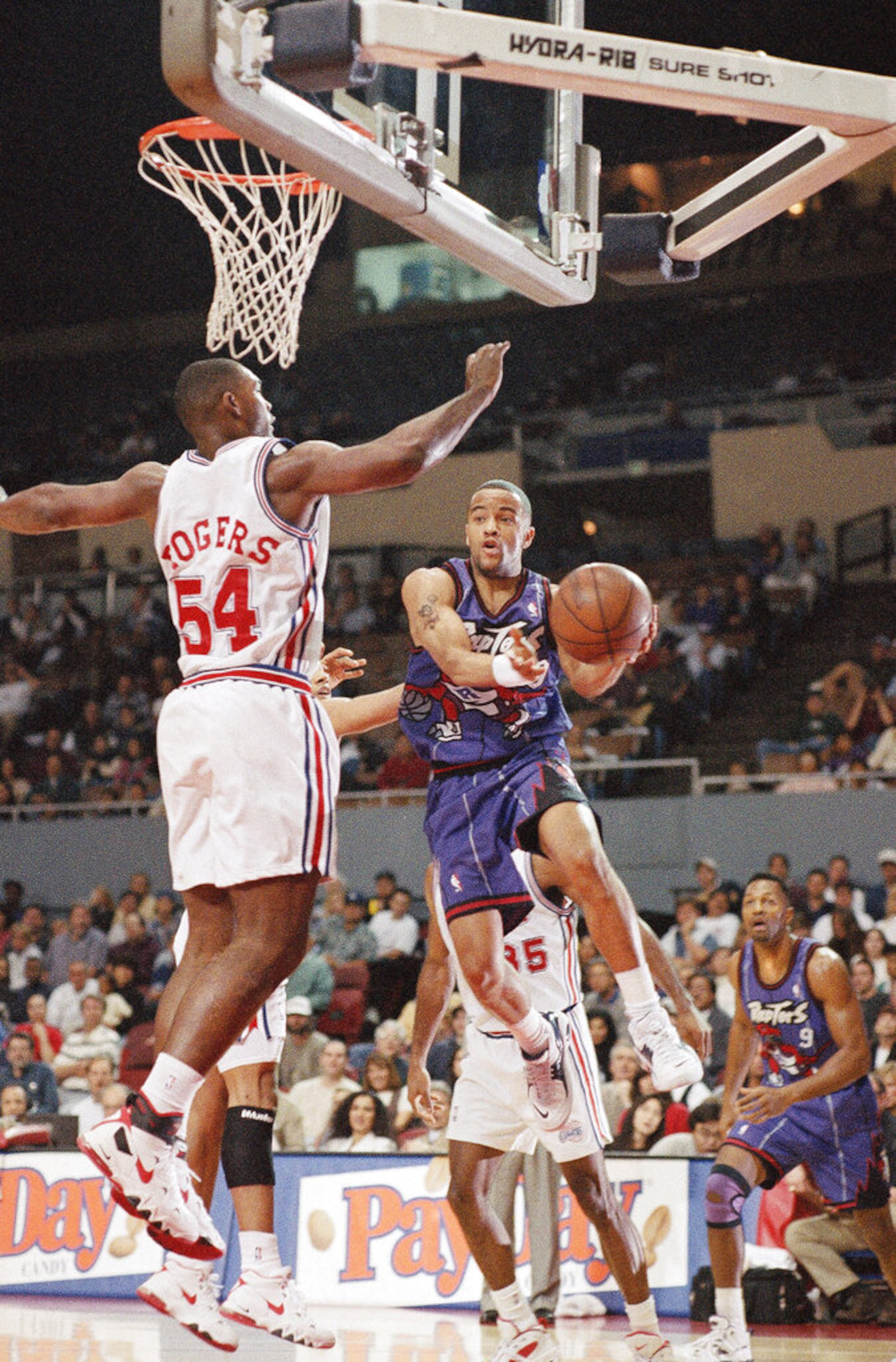 Toronto Raptors' Damon Stoudamire takes to the air against Los Angeles Clippers' Rodney Rogers in first period NBA action on Saturday, Feb. 3, 1996 at the Sports Arena in Los Angeles. (AP Photo/Michael Tweed)