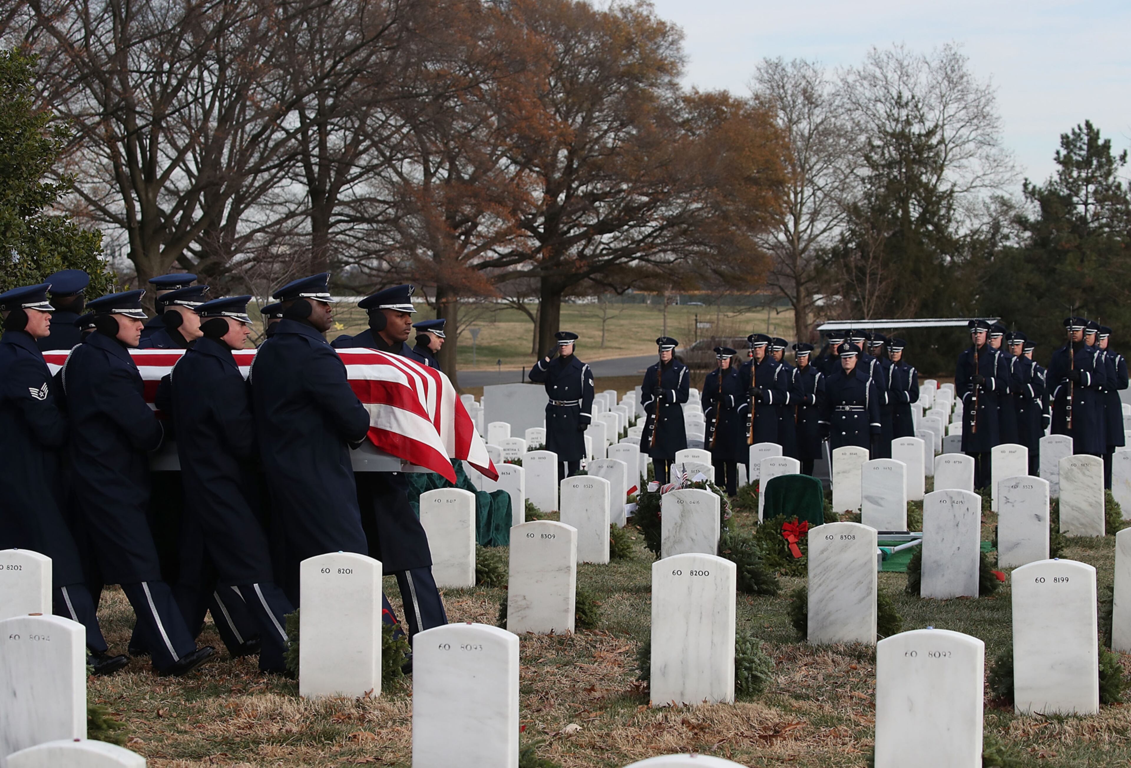 ARLINGTON, VA - DECEMBER 19: Members of the US Air Force honor guard team carry the remains of Air Force Maj. Troy Lee Smith, during a full honor burial service at Arlington Cemetery, December 19, 2016 in Arlington, Virginia. Maj. Smith killed when his F-16C Fighting Falcon crashed 20 miles northwest of Baghdad, Iraq on November 27, 2006 while engaged in support of coalition ground combat operations. (Photo by Mark Wilson/Getty Images)